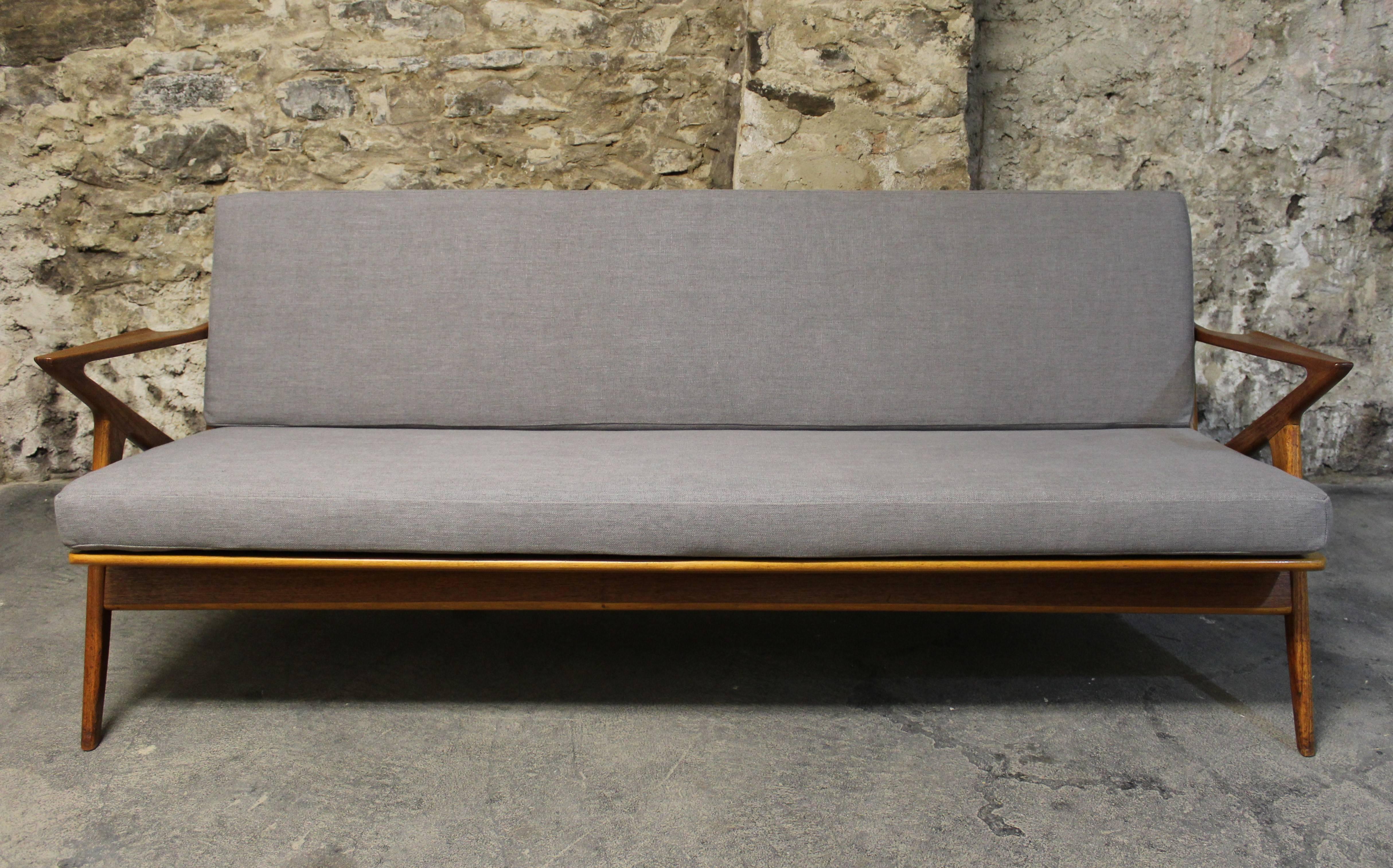 This Danish Modern Z sofa was designed by Poul Jensen for the Danish furniture company Selig OPE. The frame features Z shaped armrests (hence the name) and is made from teak wood. It has been re-upholstered in a grey fabric.

Scandinavian Modern /