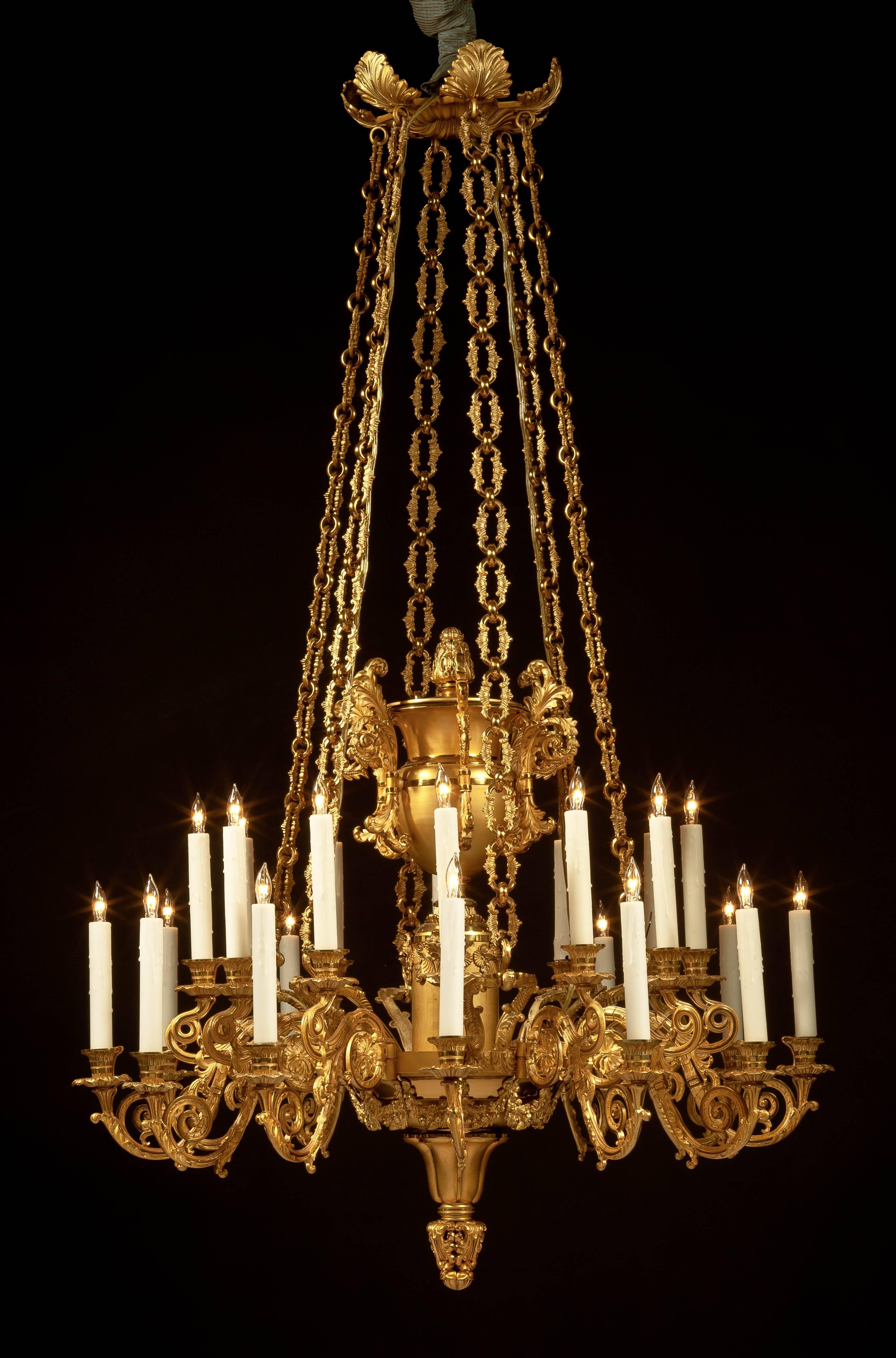 Rare and fine lacquered brass twenty-four-light chandelier.
Attributed to Messenger & Son, (active 1828-1831).
Birmingham & London, England, circa 1830.

The foliate canopy above six massive chains suspending a fixture with twelve arms, each