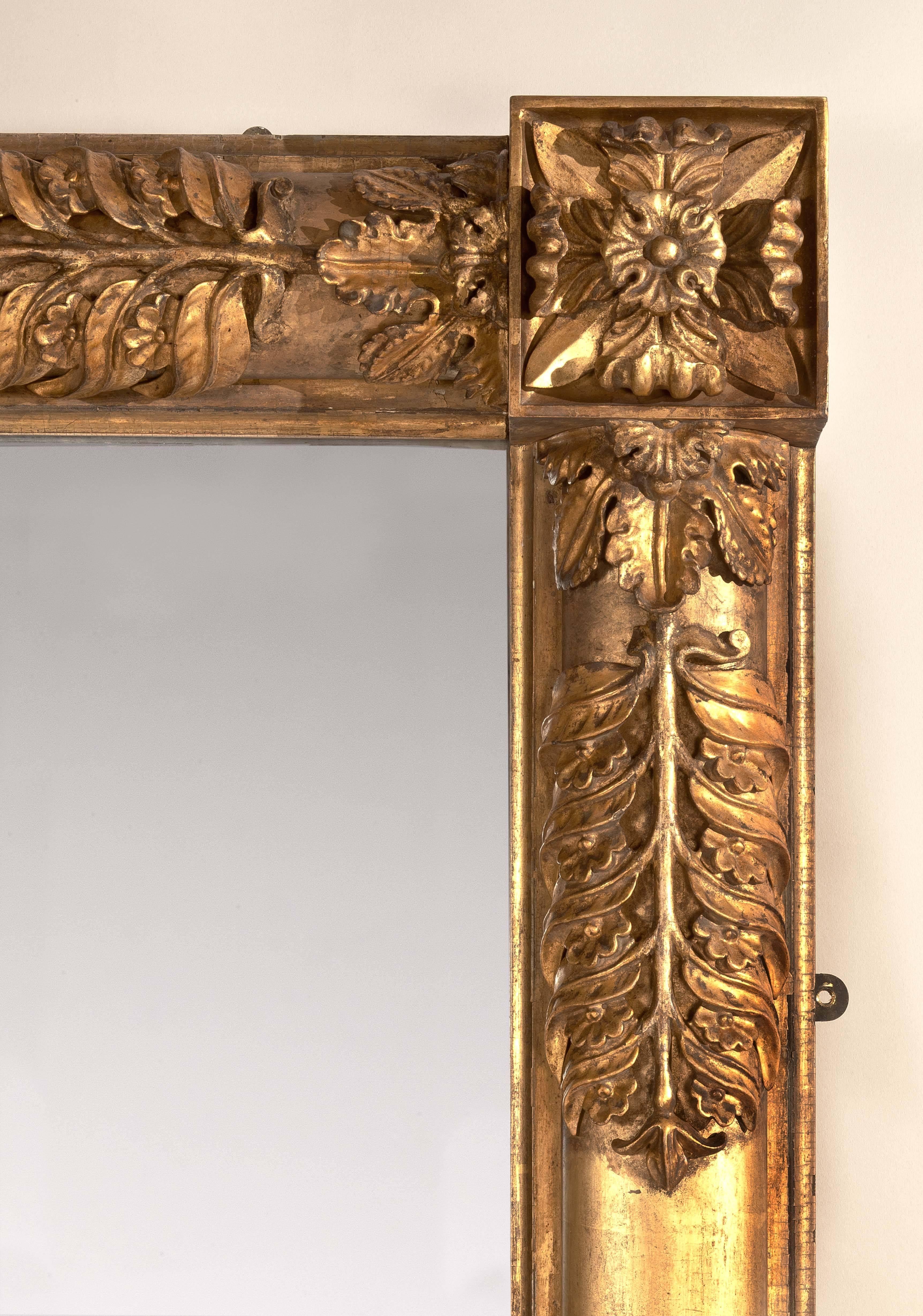 IMPORTANT CLASSICAL GILTWOOD OVERMANTLE MIRROR
WITH CARVED PALM FROND DECORATION
Attributed to John Doggett (1780-1857)
Boston, c.1835

The rectangular mirror frame with carved rosettes in each corner with engaged oval pilasters encrusted with