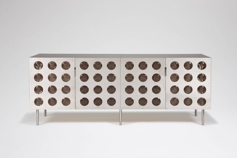 Spinoza sideboard.
Cat-Berro edition 2008.
Sideboard. Four doors. Nickel-plated brass and custom glass lenses.
Interior light system.
Polished stainless legs.
Measures: L 79”, D 18’, H 31”.
L 200 cm, H 79 cm, P 45cm.
Signed piece of a limited