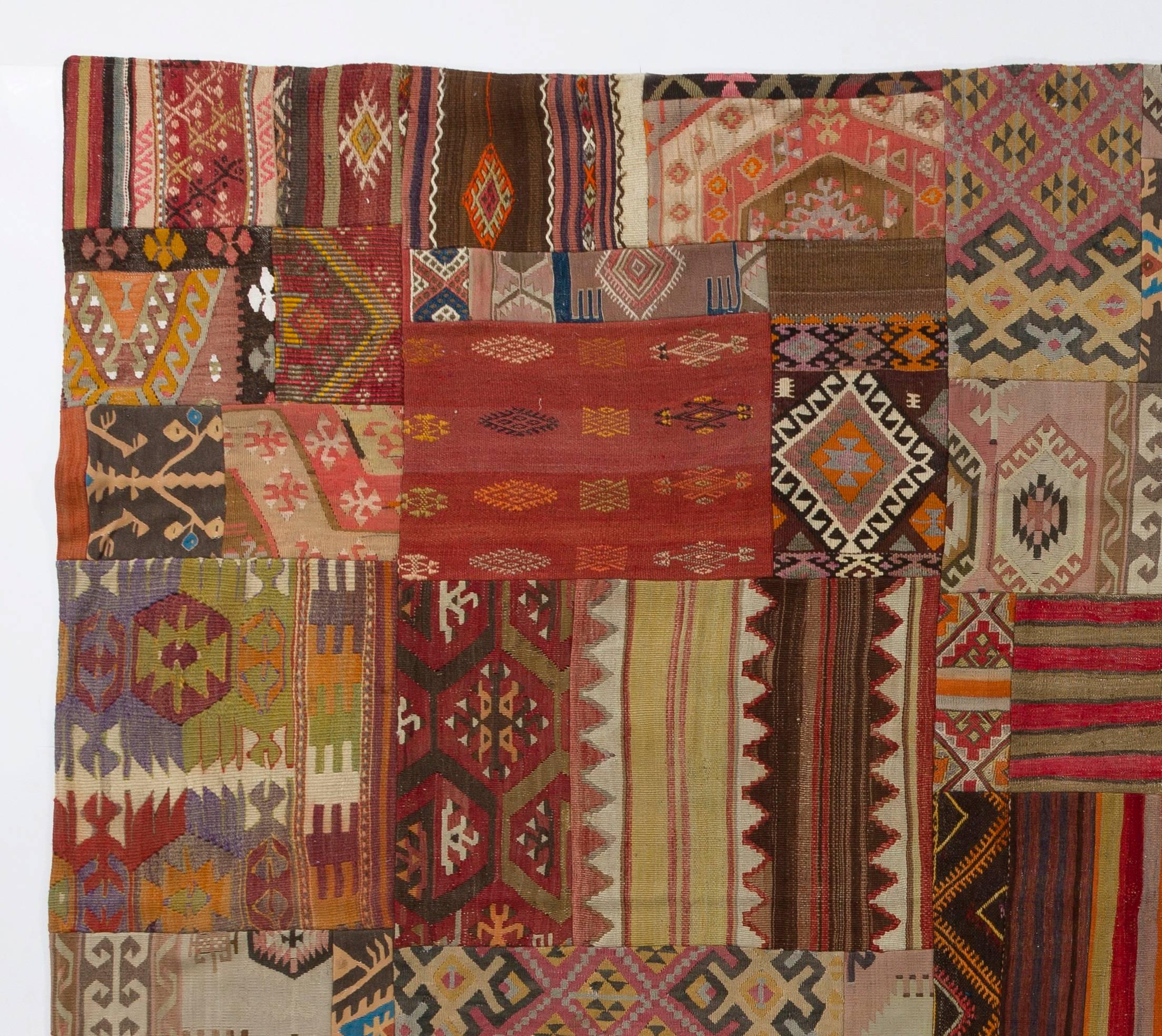 Assorted pieces of mid to early 20th century woolen Kilims (flat-weave rugs) were washed then stitched together by hand in couple of weeks to create this beautiful one of a kind patchwork rug. A durable dark color cotton twill is sewn on the reverse