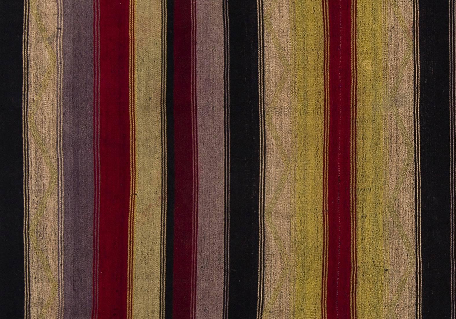 This authentic handwoven flat-weave (Kilim) from Eastern Turkey was made by Nomads to be used as a floor covering in their tents or summer houses around mid-20th century. It is made of multi colored wool.

These vintage utilitarian Kilims were
