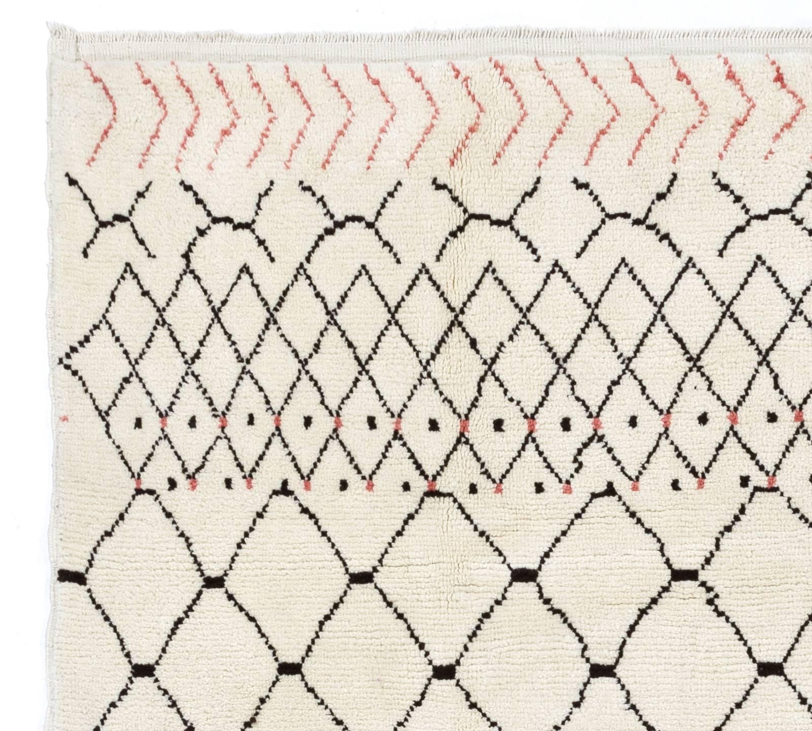 A contemporary hand-knotted Moroccan rug made of natural undyed ivory and brown sheep wool with a touch of soft pink at each end. Available as it is or made to measure in any size and color combination requested. Measures: 9 by 12 ft.