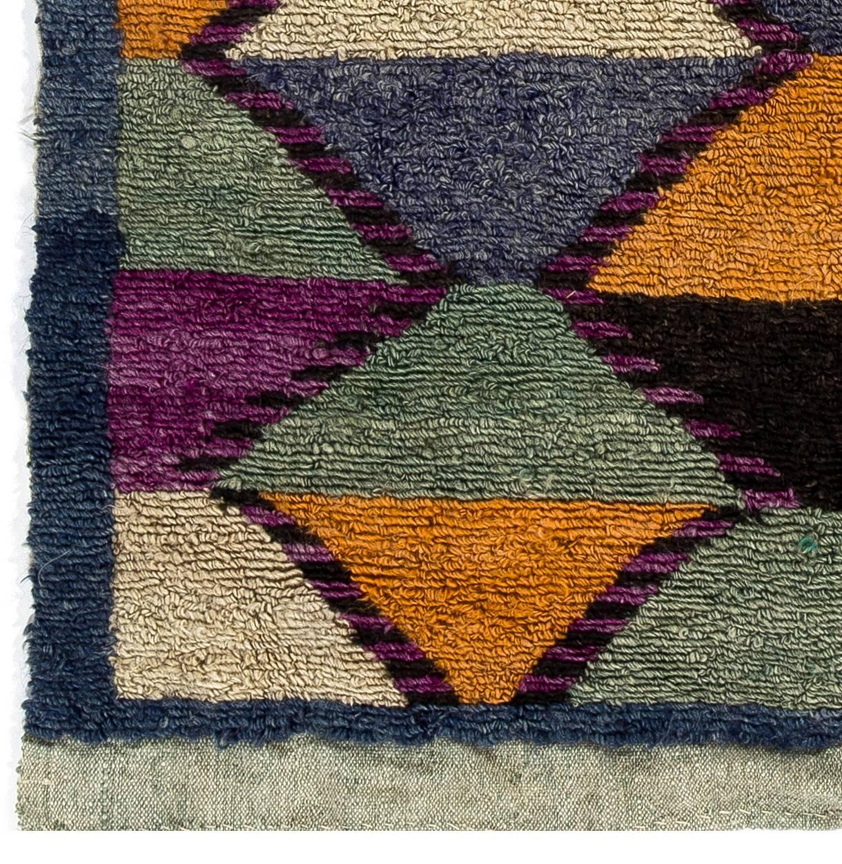 A vintage hand-knotted TULU (Turkish word for thick piled) rug from Konya in Central Anatolia, Turkey. These charming small rugs with simple and somewhat contemporary designs with lustrous wool pile were produced for daily use by villagers in Konya