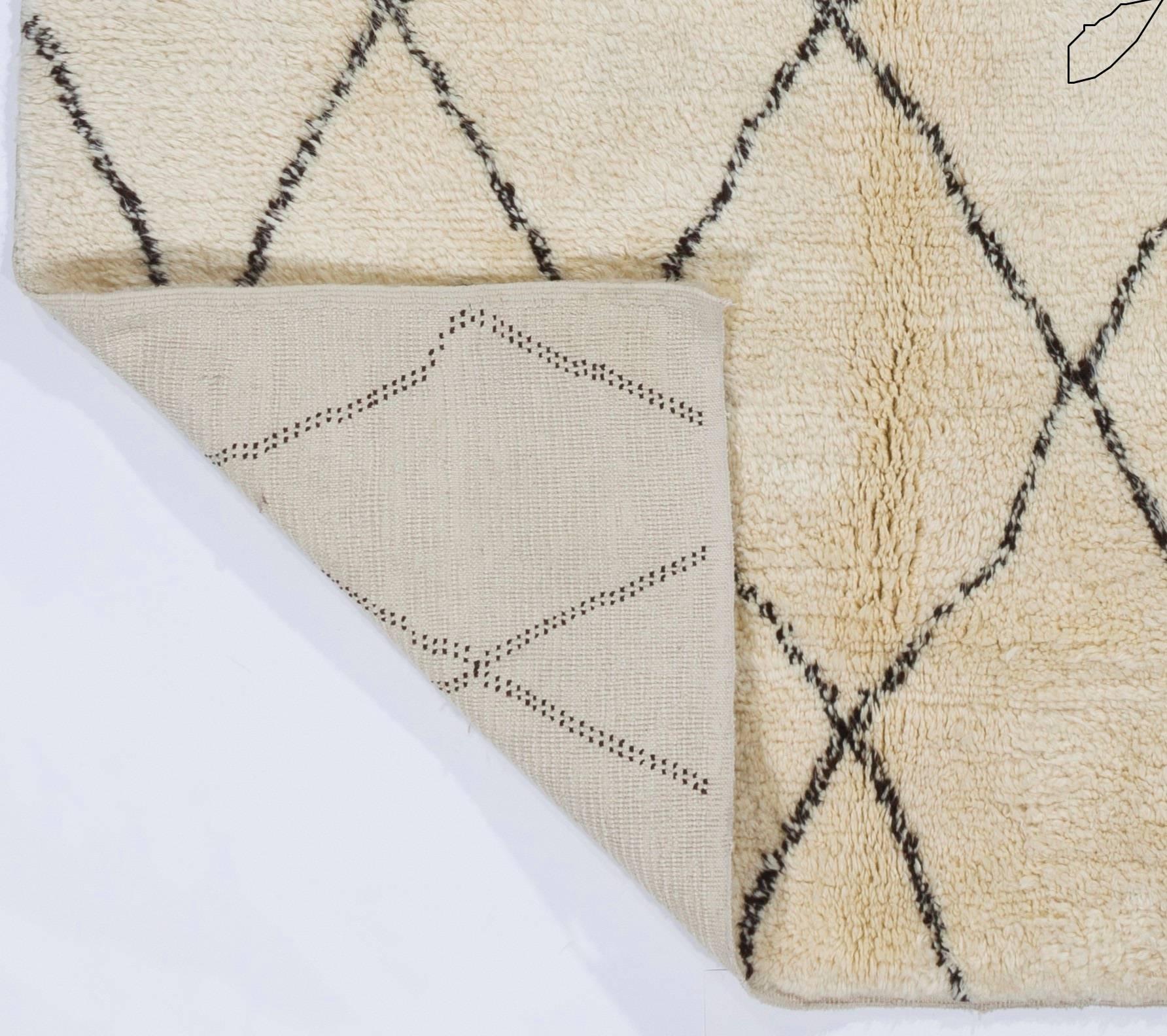 A contemporary handmade Moroccan rug with thick soft pile, made of natural undyed ivory or cream and brown wool. Available as it is or can be custom produced in any design, size, pile height and color combination requested.