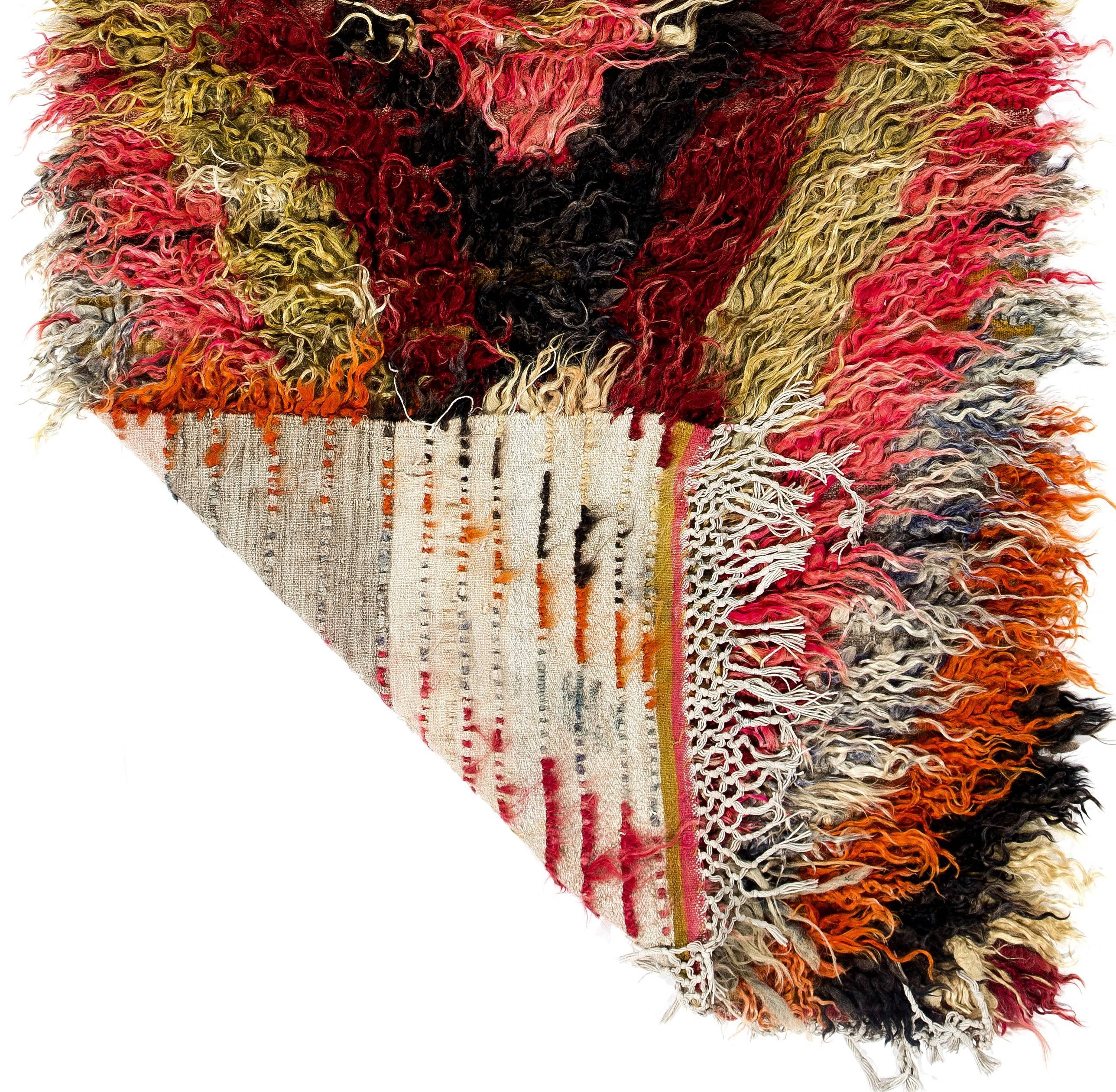 This vintage handmade rug is called "Flikli" in Turkey which is a word for a "flokati" style shag pile (Tulu) handmade rugs produced for daily use by villagers around Karapinar in Central Anatolia. This particular one is made of