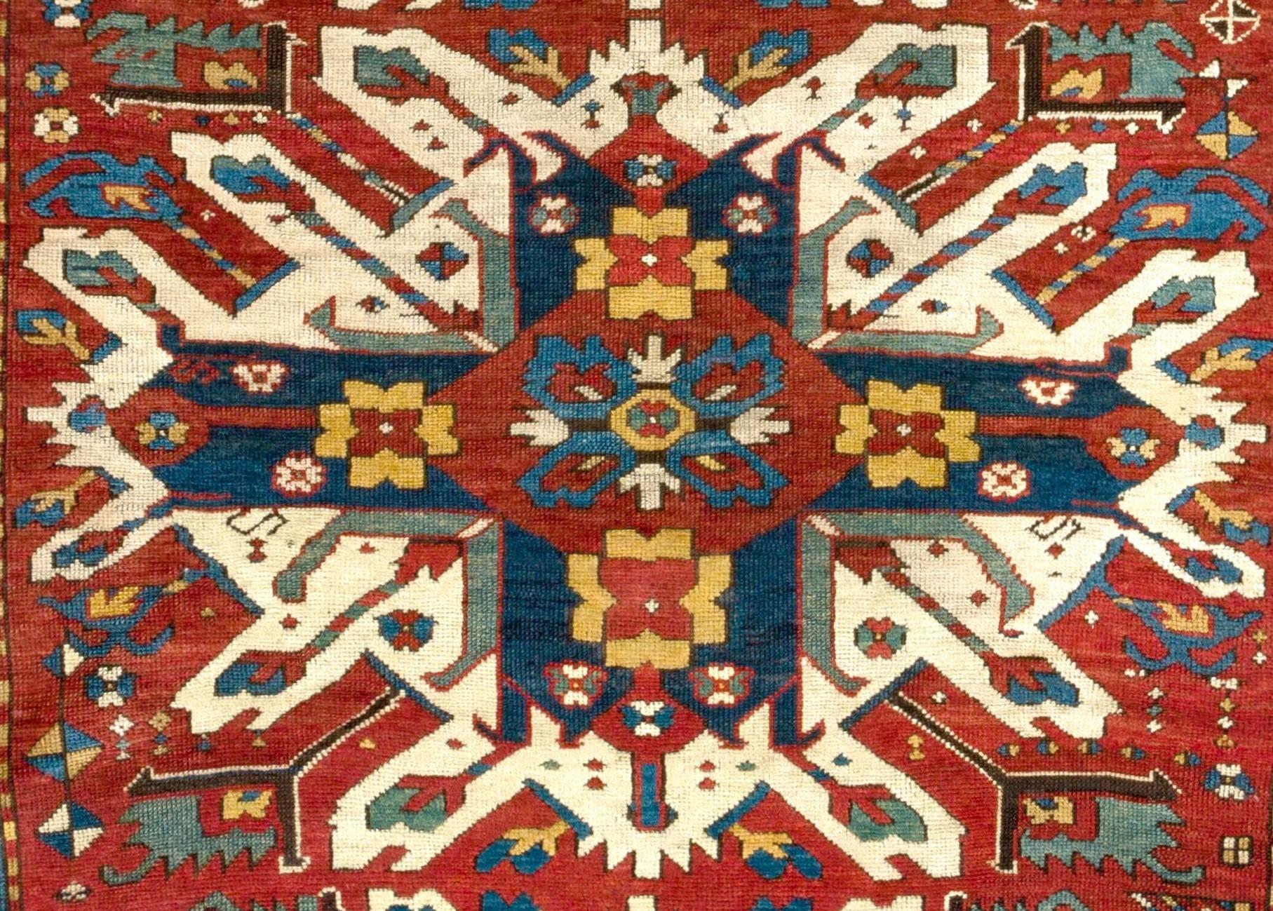 A splendid antique Caucasian rug from the village of Chelaberd in Southern Karabagh. This highly popular so called sunburst or eagle Kazak design rugs are some of the most collectible and sought after ones among all antique Caucasian works of