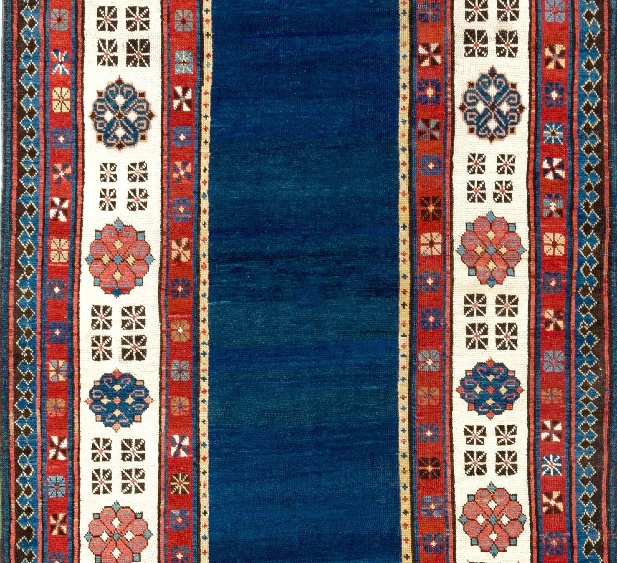 Antique South East Caucasian Talish long rug of the rare type with a plain solid blue field and a well spaced ivory border. The rug is in exceptionally good condition, ideal for a serious Caucasian rug collection.