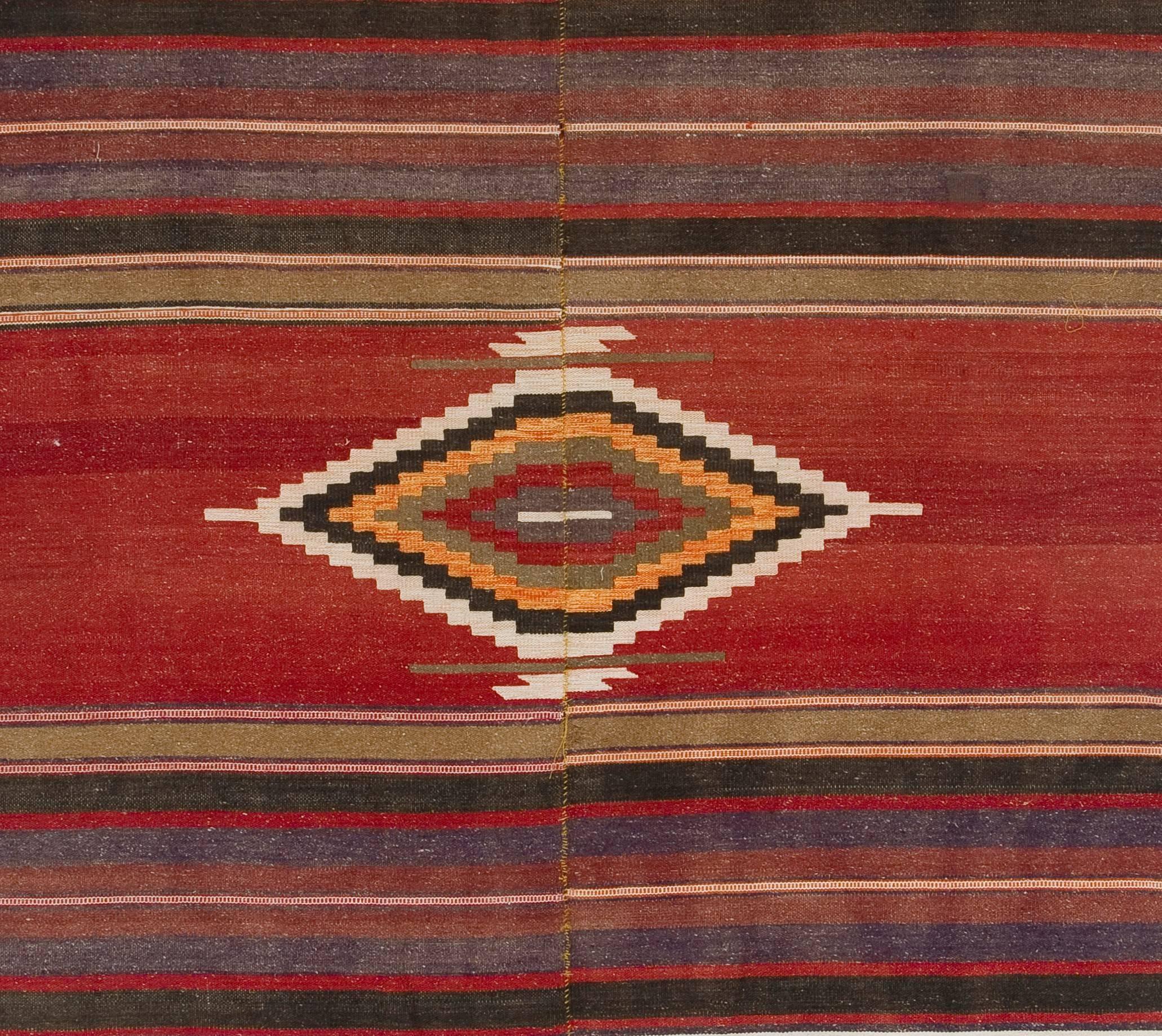 A simple yet beautiful wool rug handwoven by the Nomadic tribes in South Central Turkey. Very good condition, sturdy and clean. 100% wool. This Kilim is traditionally woven in two halves and connected in the center.
 