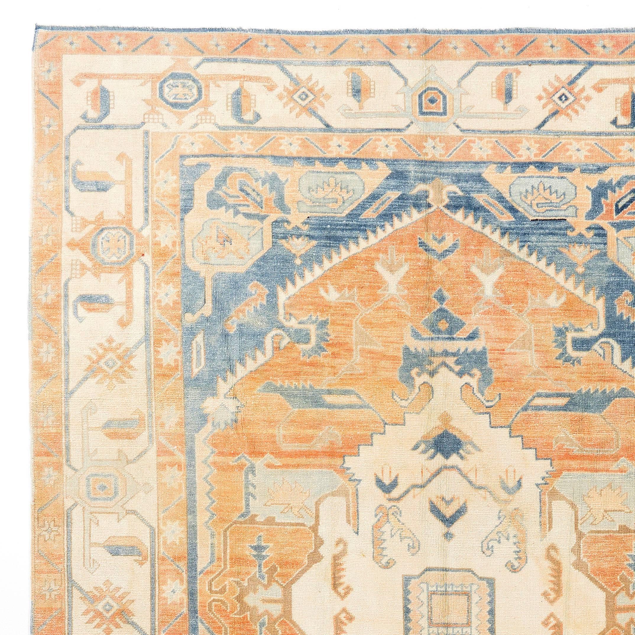 A vintage handmade Central Anatolian rug with a bold design and beautiful soft blue, rust and beige colors. Finely hand-knotted with even medium wool pile on wool foundation, excellent condition. Sturdy and as clean as a brand new rug. The rug has
