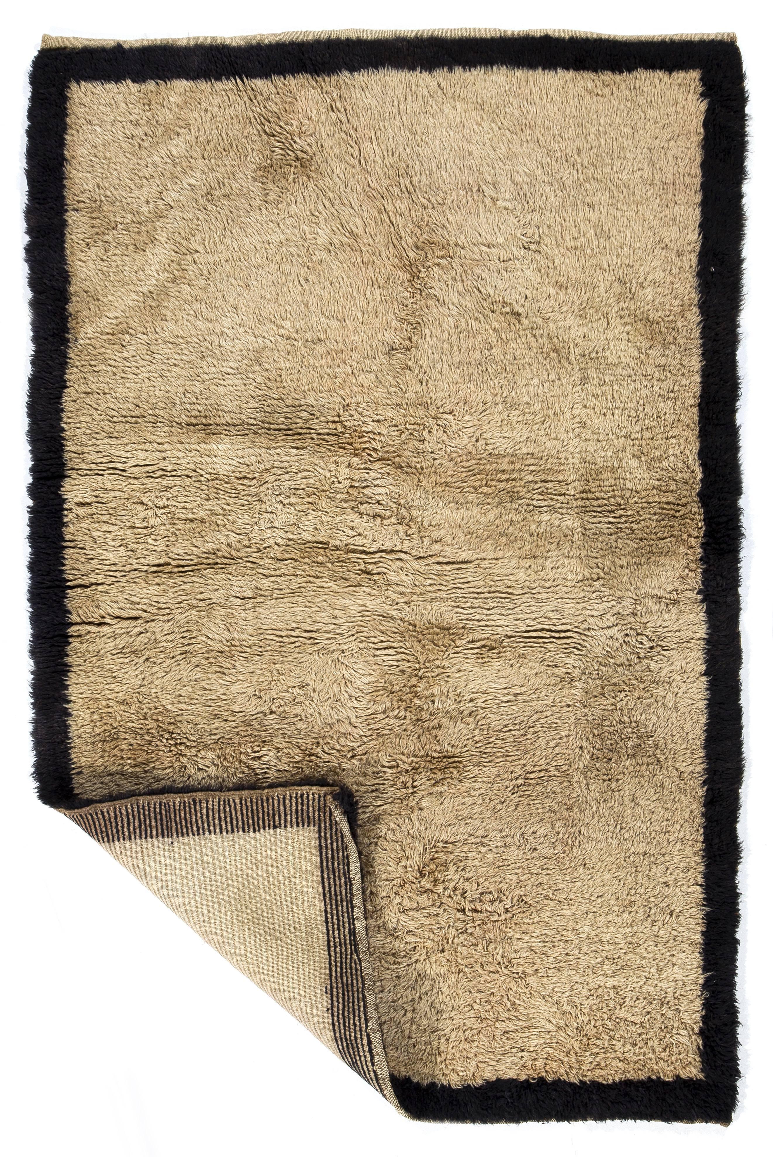 A vintage hand-knotted Tulu (Turkish word for long/thick piled) rug from Konya in Central Anatolia, Turkey. 100% natural undyed hand-spun lambswool.

These simple, functional, small rugs with clear, plain design and lustrous wool pile were made for