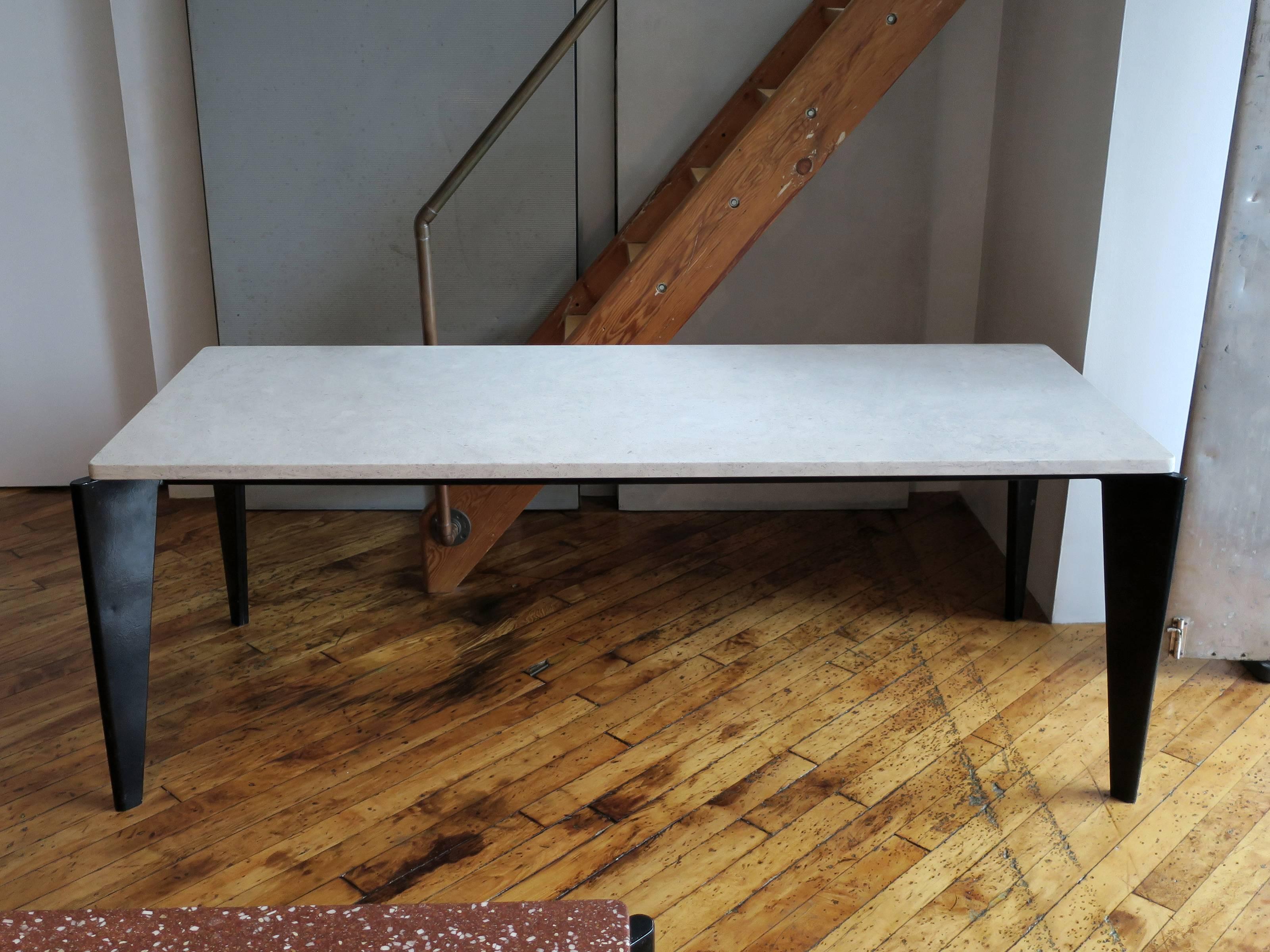 A rare, early Flavigny dining table designed by Jean Prouvé, manufactured by Ateliers Jean Prouvé, circa 1945. Bent sheet metal frame with limestone top. Top is a later replacement which is very common of this early table. 

Note from the Jean