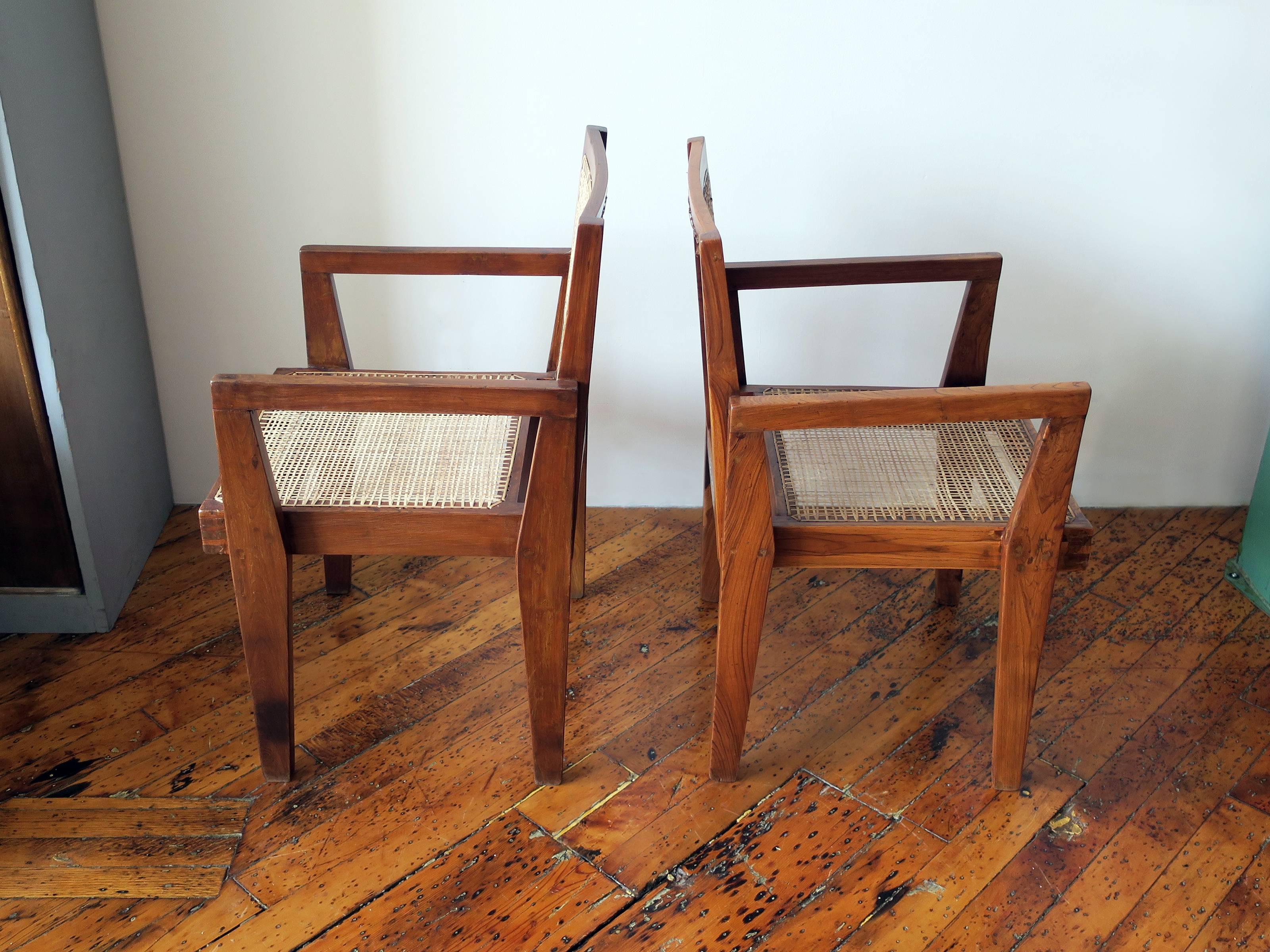 Beautiful pair of a Pierre Jeanneret clerk's armchairs from the high court, Chandigarh. Numbers present on back of chairs. Restored condition. Dimensions vary slightly due to the handmade nature of the design.