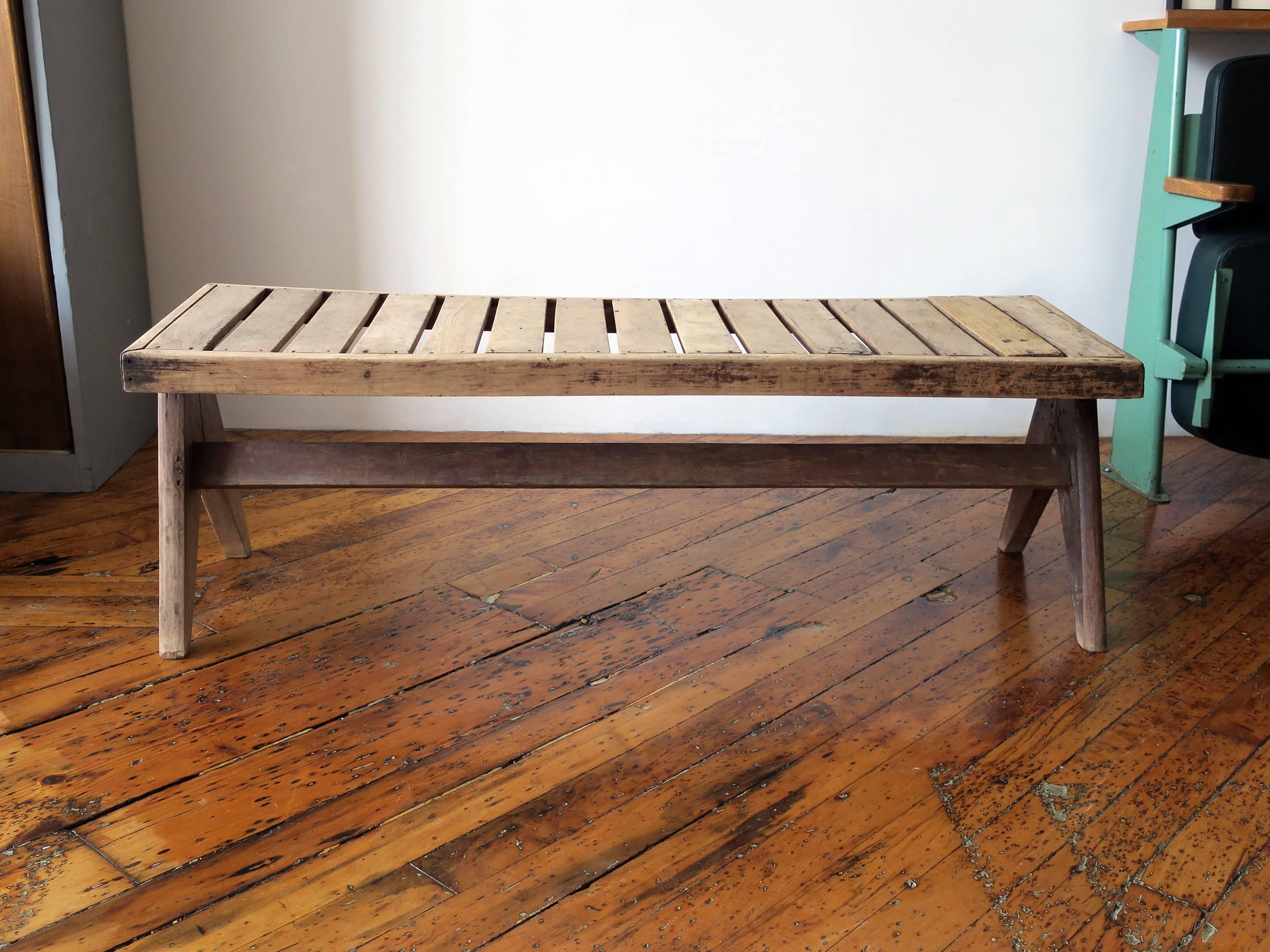 Original, sun bleached teak Pierre Jeanneret bench from Chandigarh. One slat appears to be an old replacement and some minor repairs, executed over the decades, are visible.