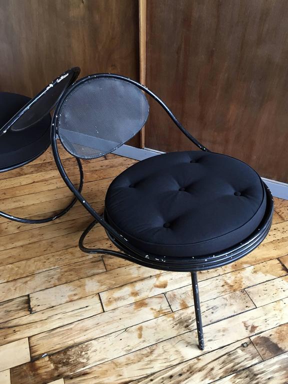 Pair of steel "Copacabana" chairs by Hungarian or French designer and material artist Mathieu Matégot. Manufactured by Atelier Matégot, France. Plush canvas cushions newly made in New York City by expert restorer. Highly durable for