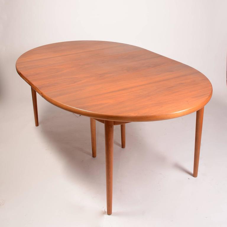 This is a beautiful early Scandinavian Modern dining table in teak imported by Moreddi. It includes two large leaves each measuring 19.75 and can seat ten comfortably. It features expert design and extra heavy construction. 
Total length with leaves