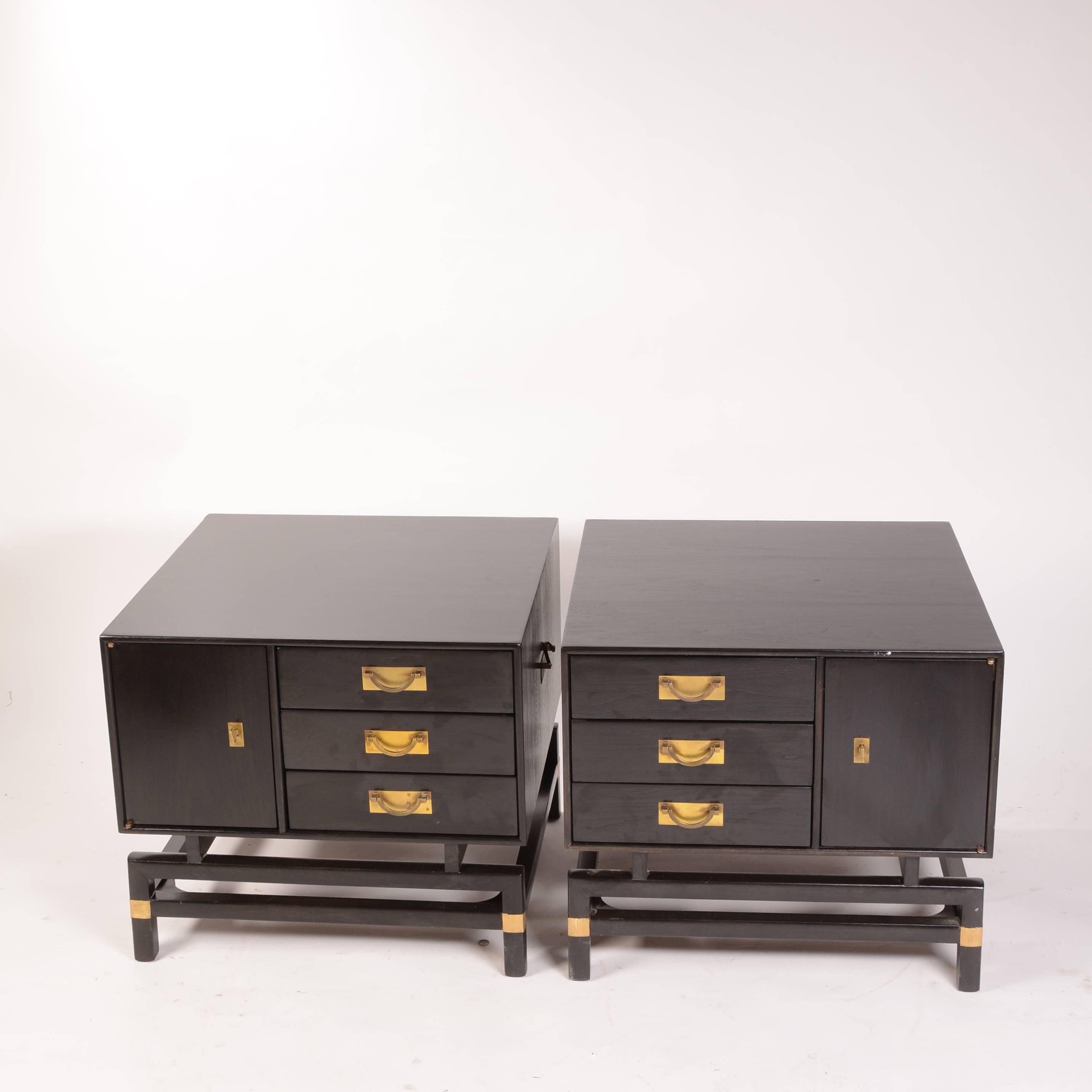 Pair of ebony and brass walnut cabinets/end tables, stamped Hickory Manufacturing Co, interior space, with three drawers.