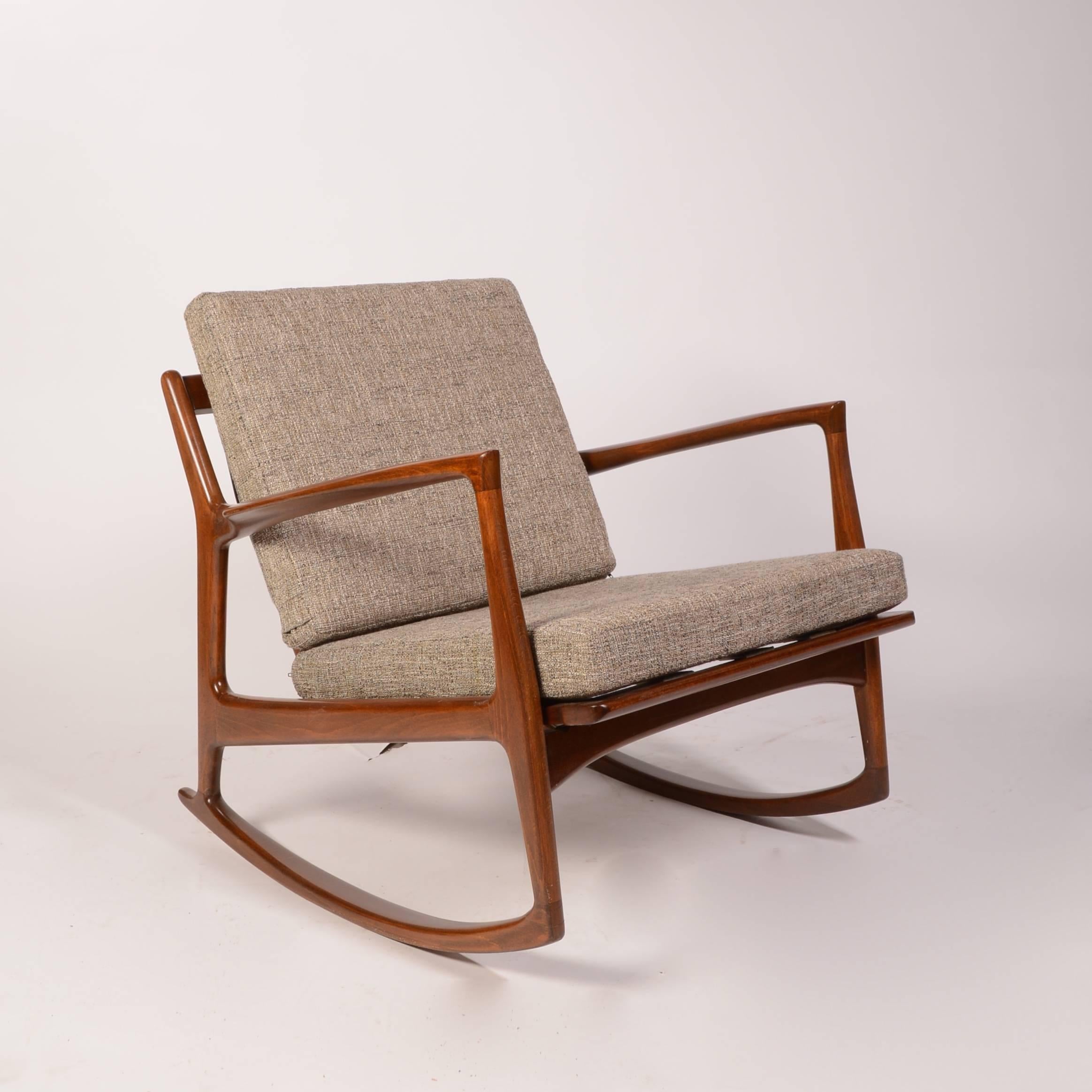 A gorgeous low back rocking chair designed by Kofod-Larsen and produced by Selig in Denmark in the 1960s. 

Solid walnut frame. This rocking chair has the Selig medallions maker's mark. Includes new cushions. 

The seat webbing as been newly