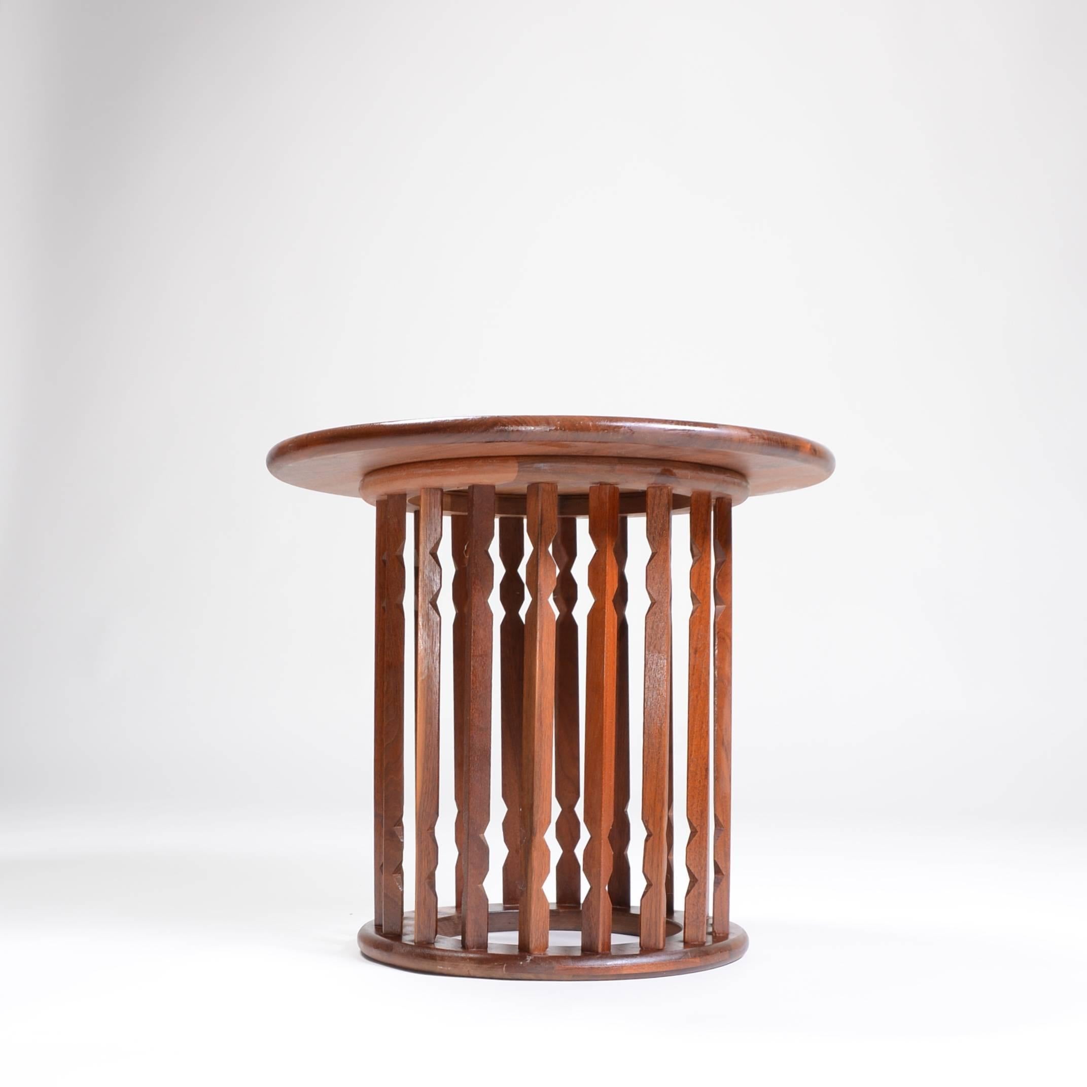This is solid walnut end table in the style of Arthur Umanoff.