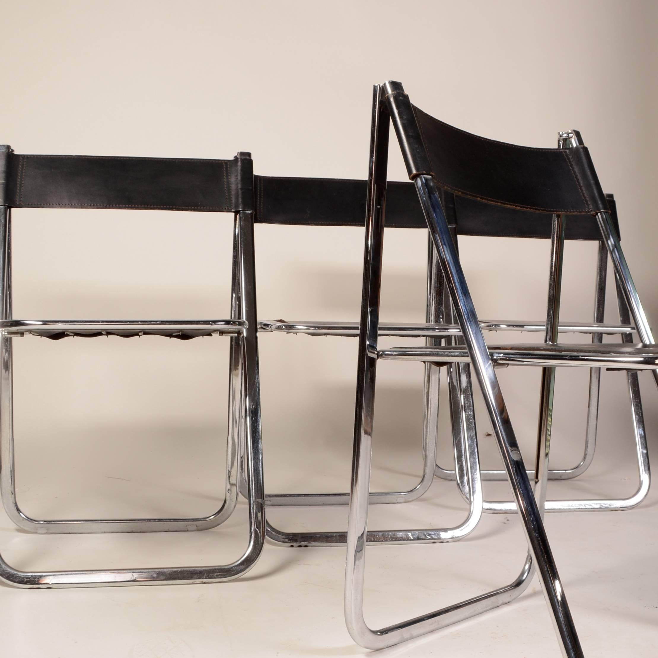 A rare set of vintage Italian Tamara chairs made by Arrben. Sleek and modern with polished chrome frames and black saddle leather. Includes the original seat spring construction. 
Marked Arrben/Italy on the upper end cap.