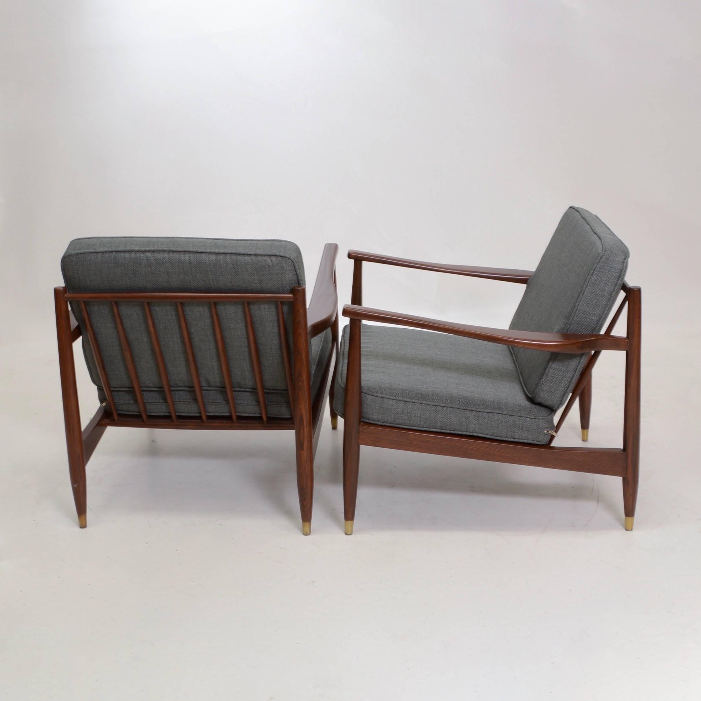 This is a newly restored pair of Mid-Century armchairs in the manner of Grete Jalk. This set includes two refinished chairs and four new cushions.