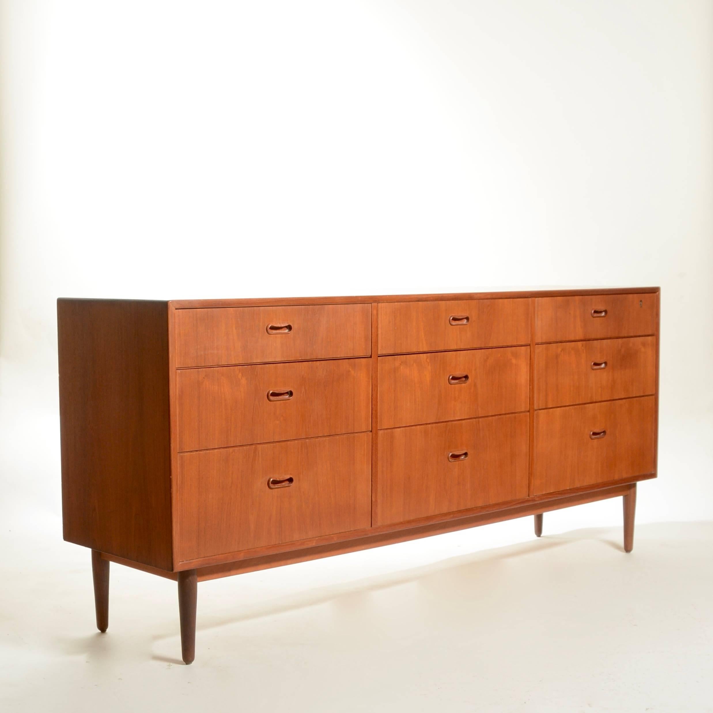 Well designed nine-drawer triple teak dresser by Falster Mobelfabrik. Made from beautifully selected and matched teak veneer over hardwood ply construction and solid maple drawer boxes. This dresser is in excellent condition! We have the matching