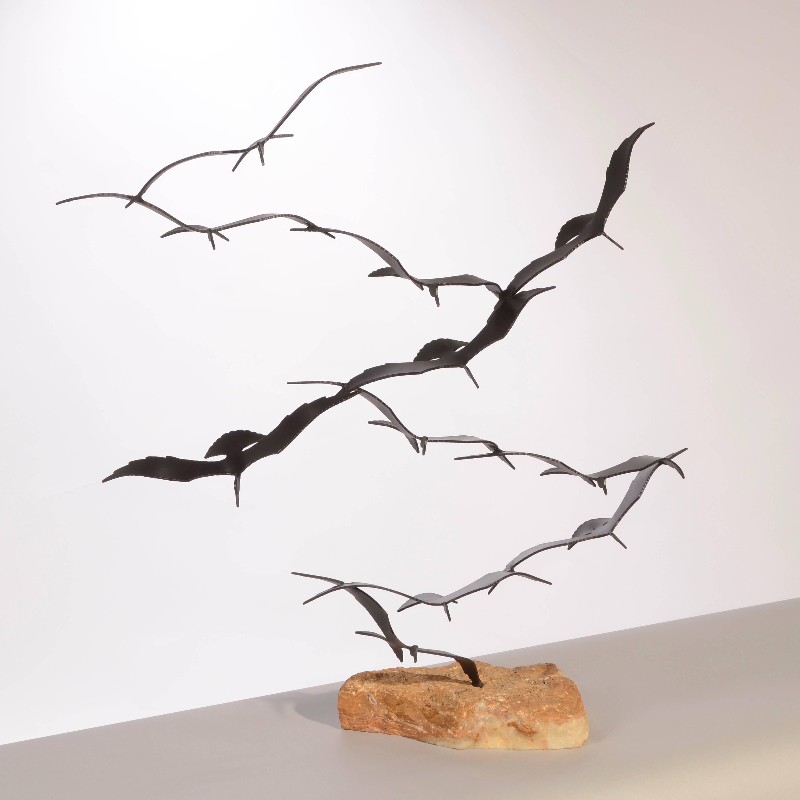 A kinetic sculpture, this flock of seagulls is poetry in motion. The rough cut of the onyx base contrasts to the lightness and smoothness of the flying birds made from solid brass.