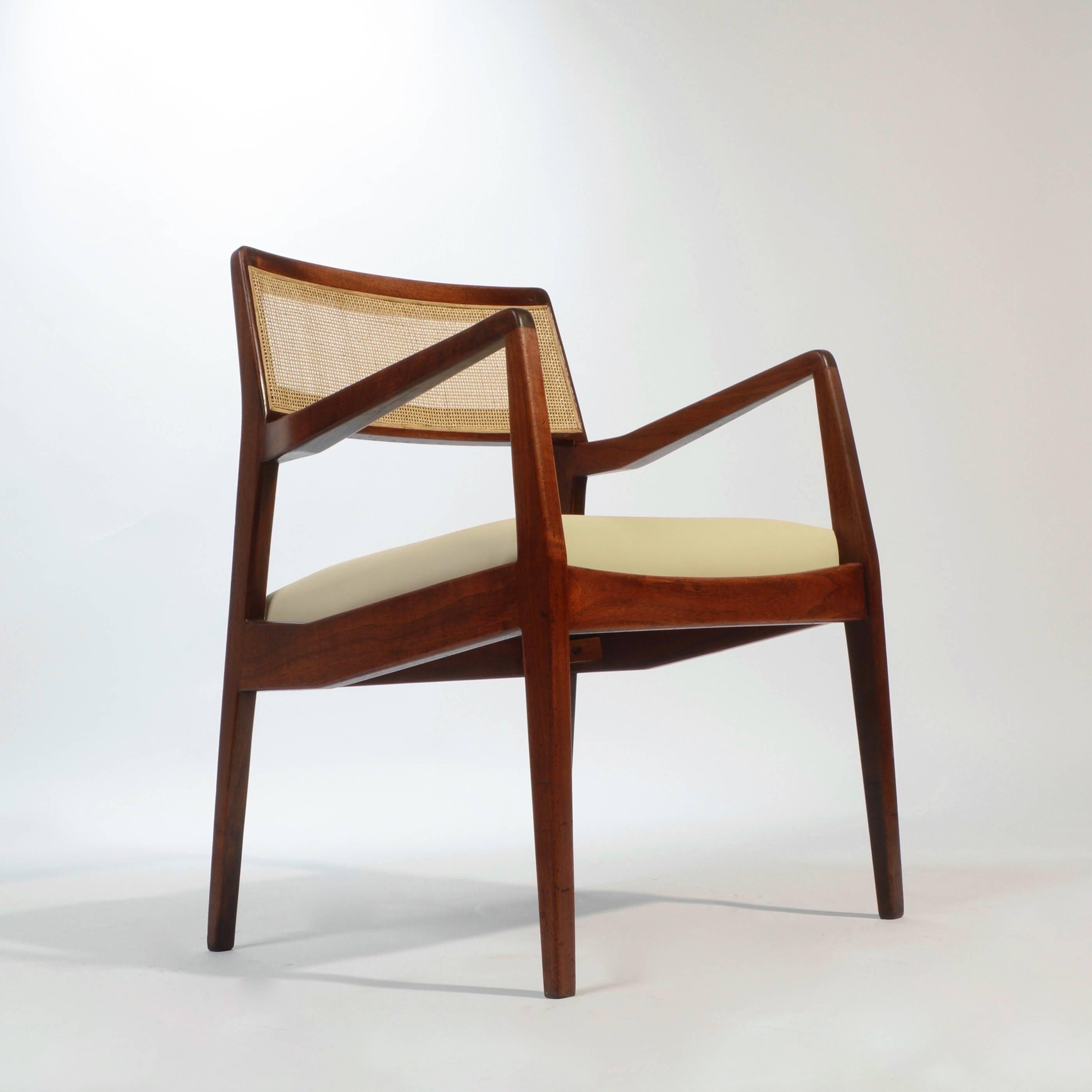 Set of four fully restored Jens Risom 'Playboy' chairs, model C140. This set features all new cushions and leather upholstery, new professionally installed cane, and newly oiled walnut.