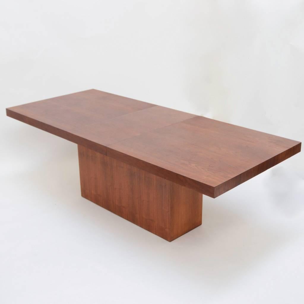 An adjustable full length walnut dining table by Milo Baughman.