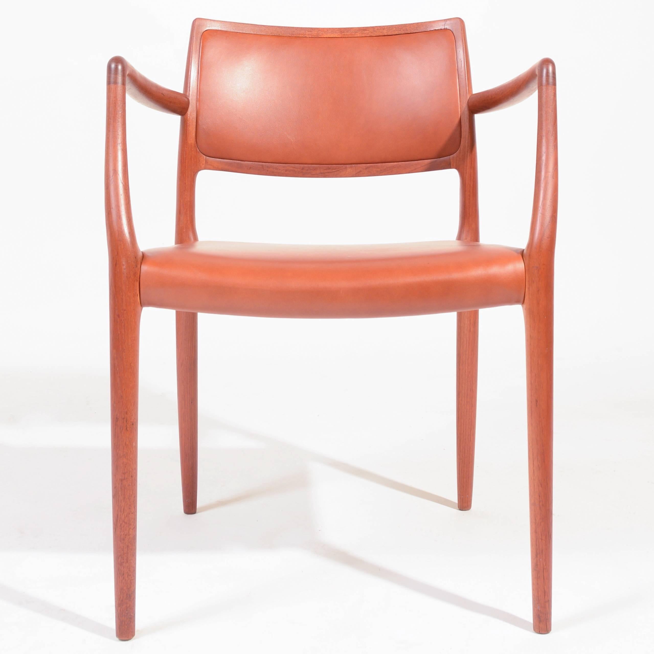 Pair of two teak dining chairs designed by Niels Otto Møller for J. L. Møllers Møbelfabrik. The model 80 dates to 1968 and is an exceptional chair offering a very comfortable posture and the warm modern look typical of great Danish design. Newly
