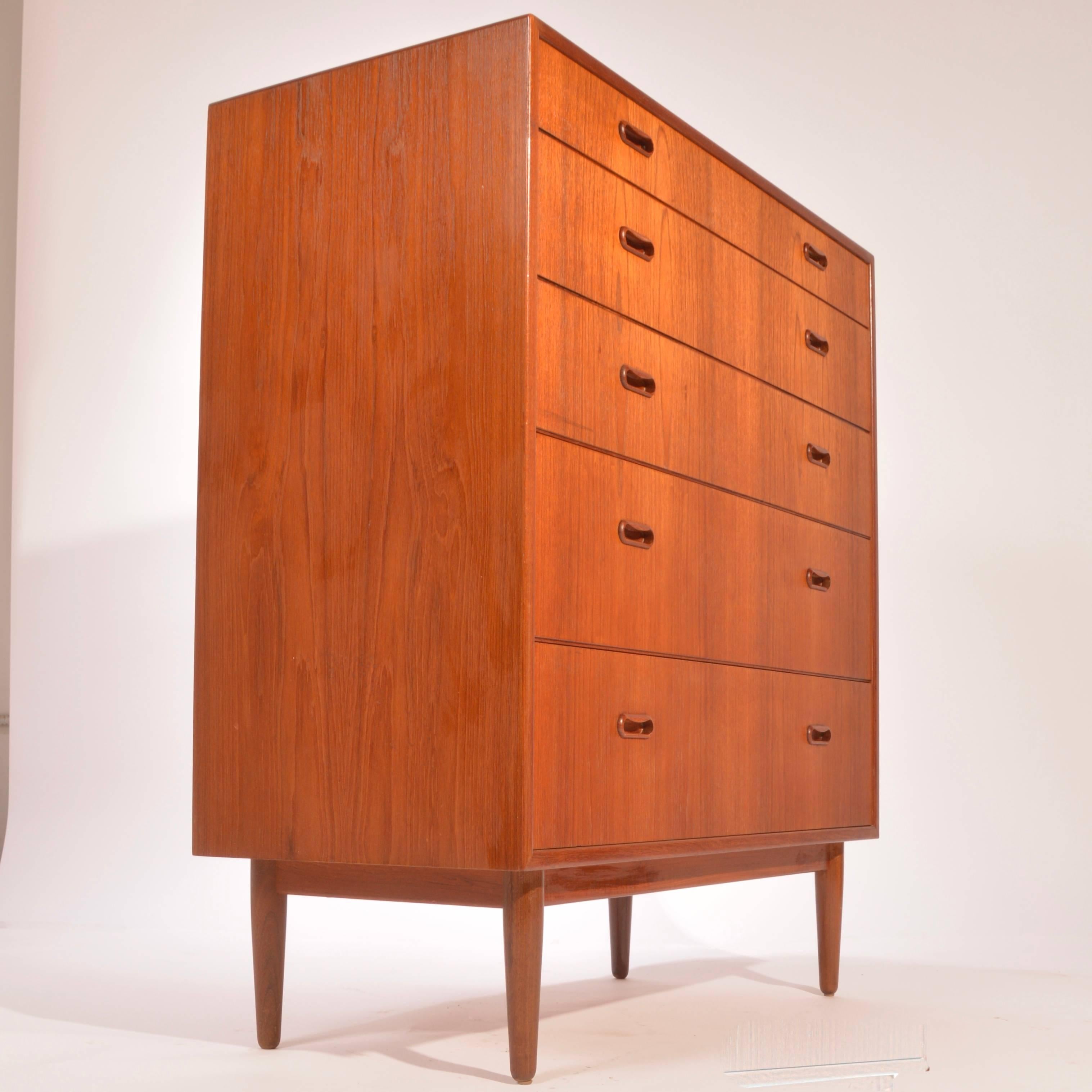 Well-designed tallboy teak dresser by Falster Mobelfabrik. Made from beautifully selected and matched teak veneer over hardwood ply construction and solid maple drawer boxes. We have the matching nine-drawer triple teak dresser available in a