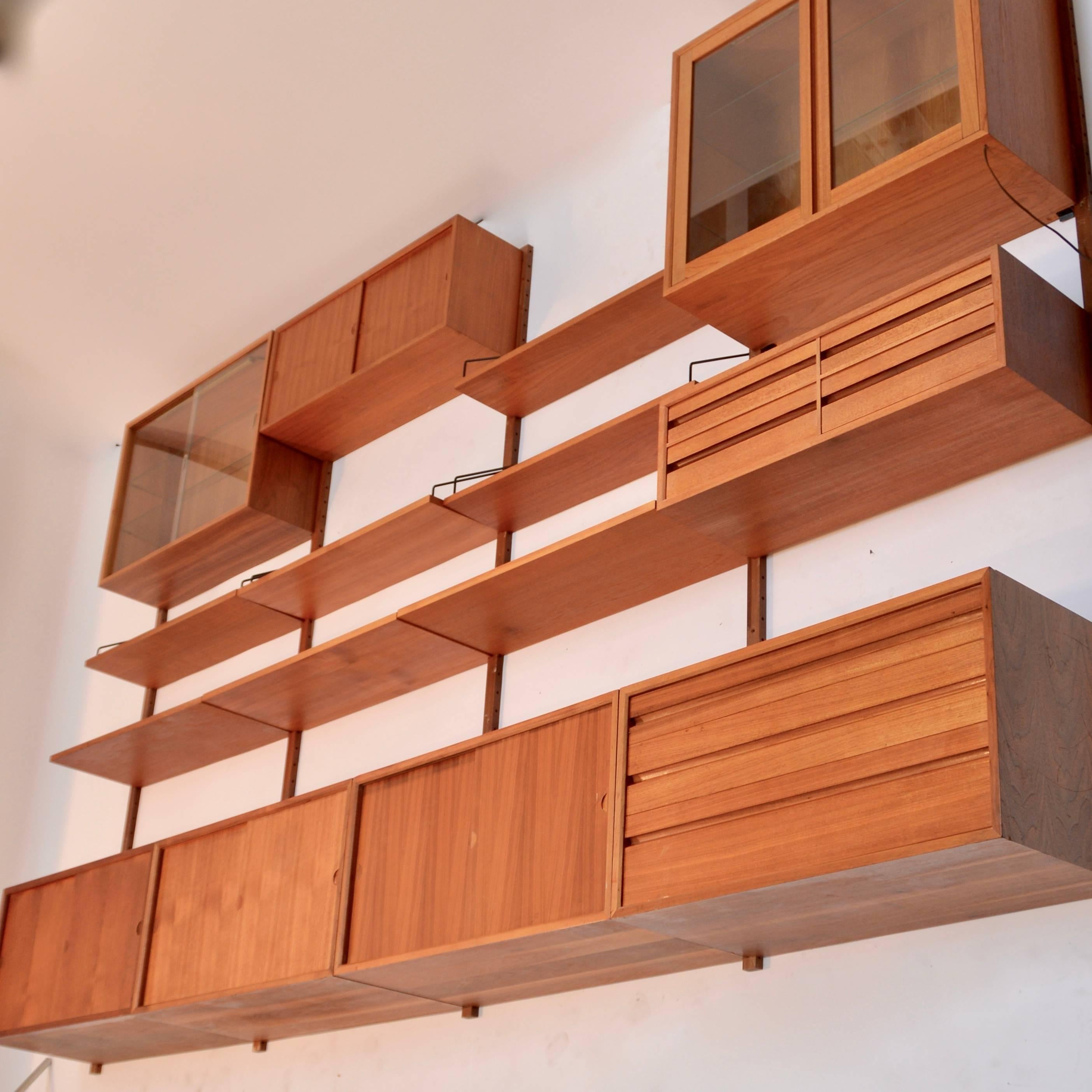 Highly versatile and functional Cado wall unit in walnut by Danish designer Poul Cadovius. 
We currently have many different Cado pieces in stock and can customize your order to include the type and number of pieces you need. We have both the Royal