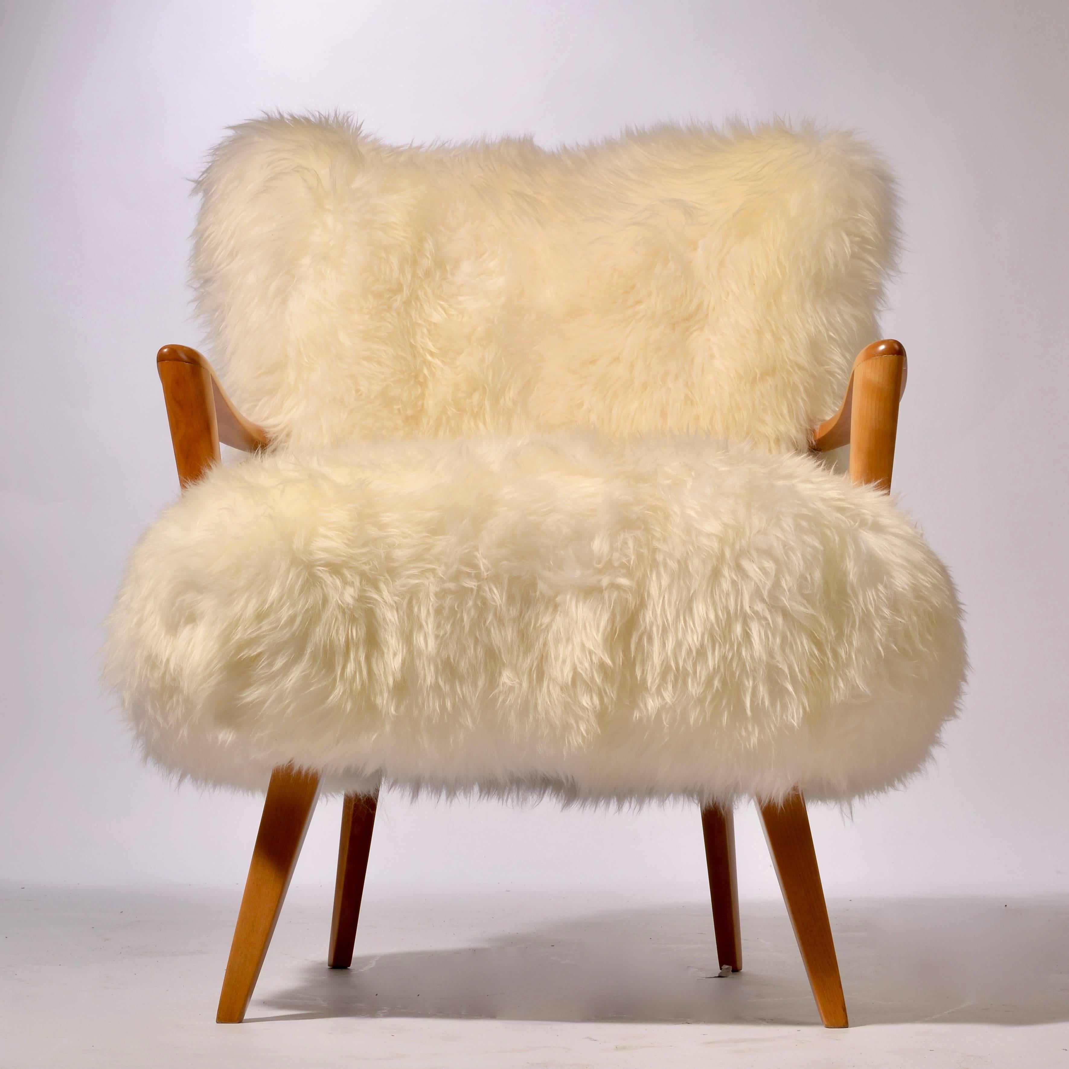 This is a rare Heywood Wakefield lounge chair upholstered in sheepskin and refinished.