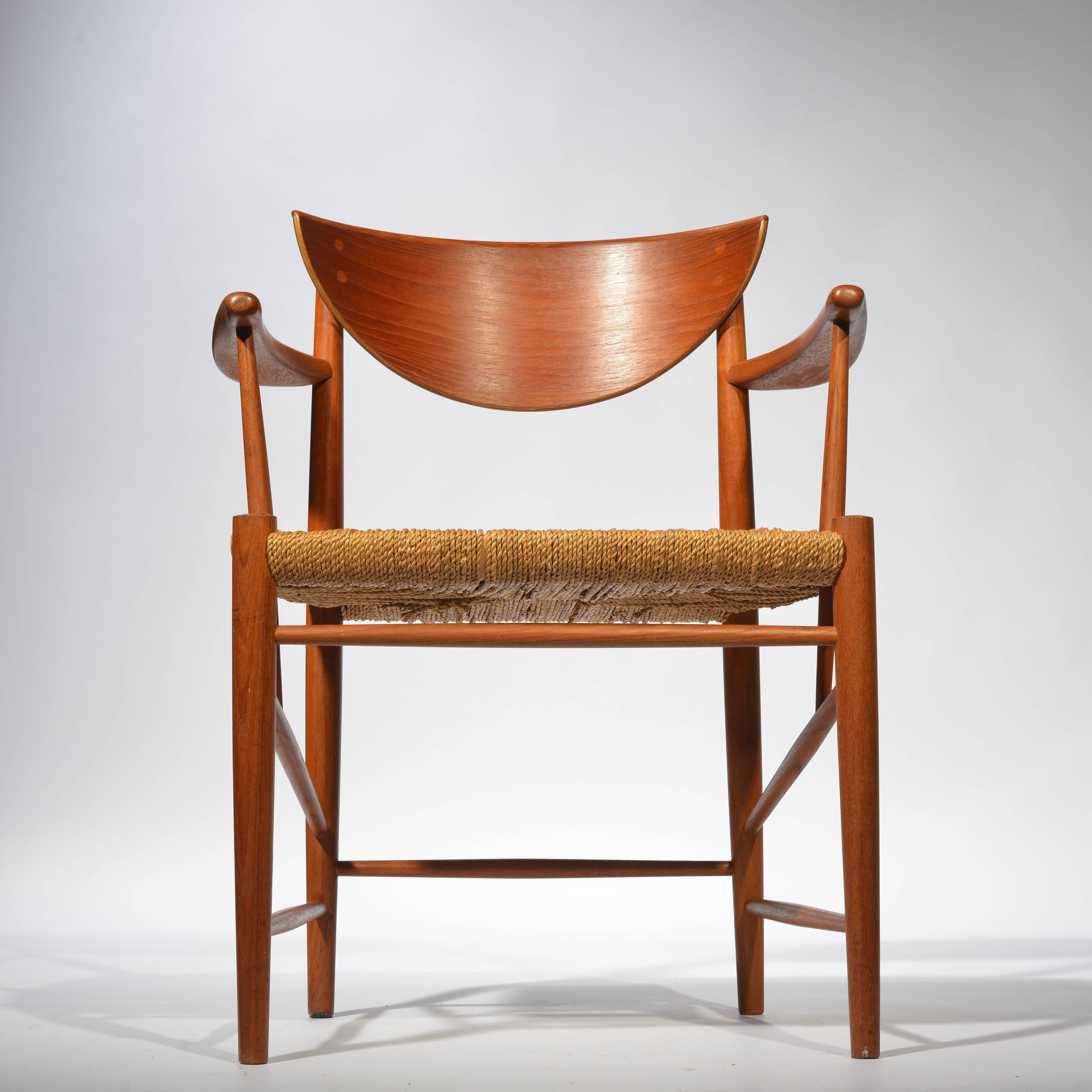 Mid-Century Modern Danish armchair in teak, model 317, by Peter Hvidt & Orla Mølgaard Nielsen. Original cord seat.