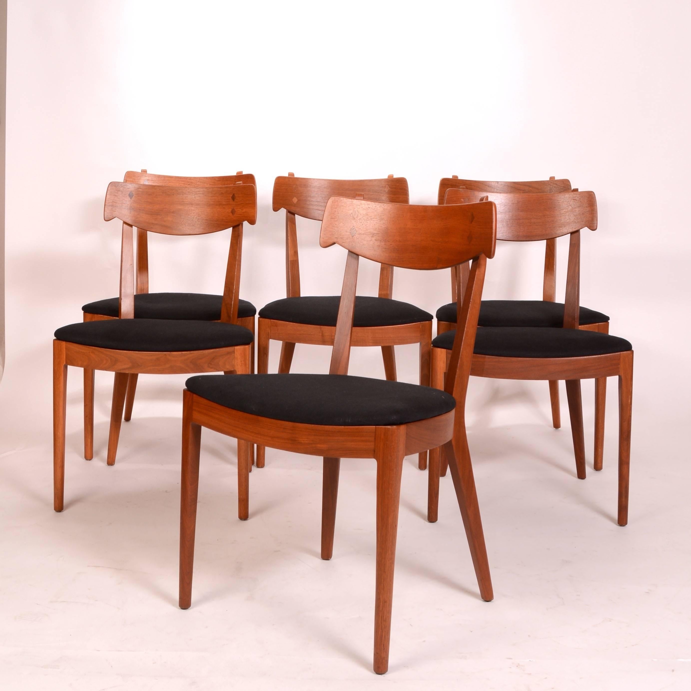 Finely sculpted walnut dining chairs designed by Kipp Stewart and Stuart MacDougall for Drexel, circa 1950. This set is in excellent condition.  The wood retains its beautiful original color and finish.  We have 4 other chairs listed if more are