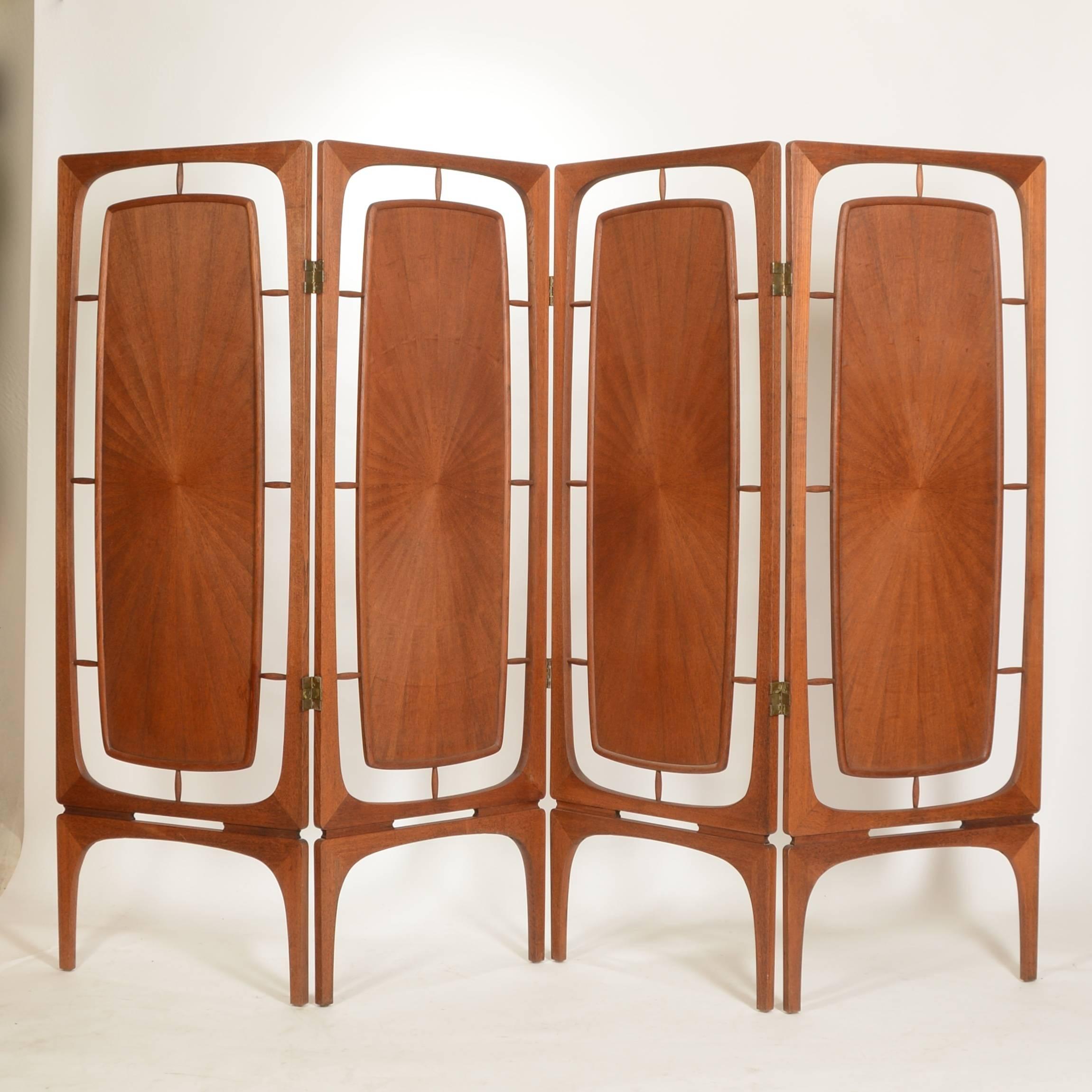 This is a beautiful and rare teak four-panel folding screen from Denmark, circa 1950.  Made from hand formed solid teak frames with radiating bookmarked veneer inserts and carved reliefs.  The condition is excellent. 