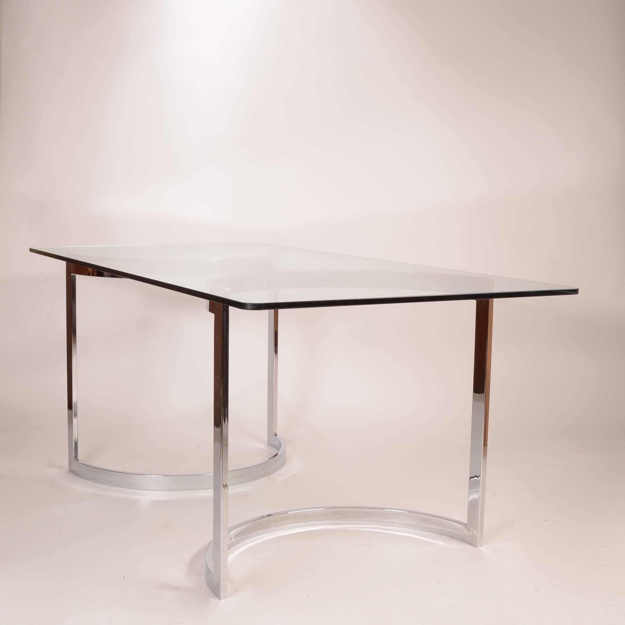 This is a beautiful dining table in the style of Milo Baughman.  The legs can be arranged in a variety of positions.  The glass is in excellent condition.  