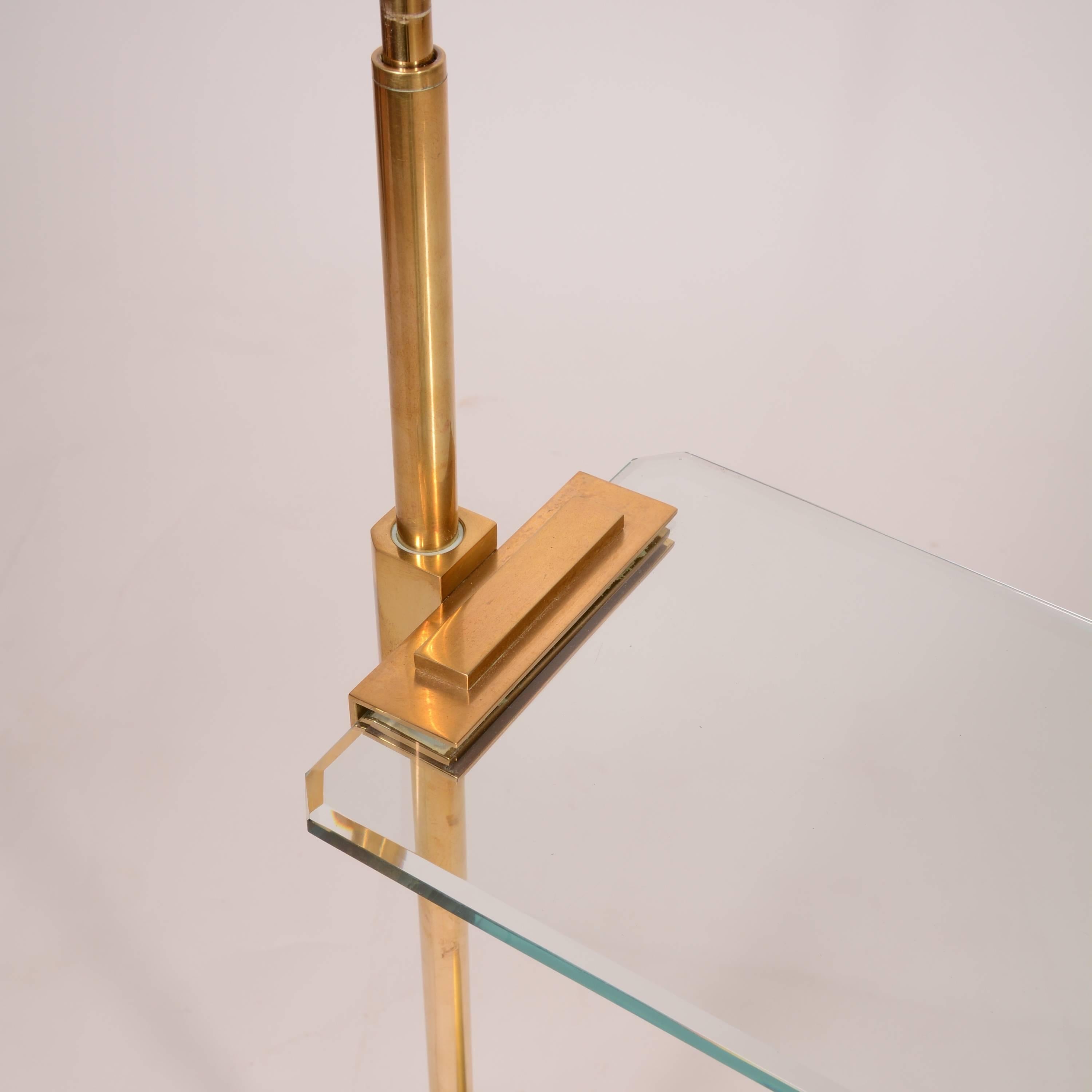 This is an elegant yet modern heavy brass and glass floor lamp by Casella.  This piece is in great condition.  