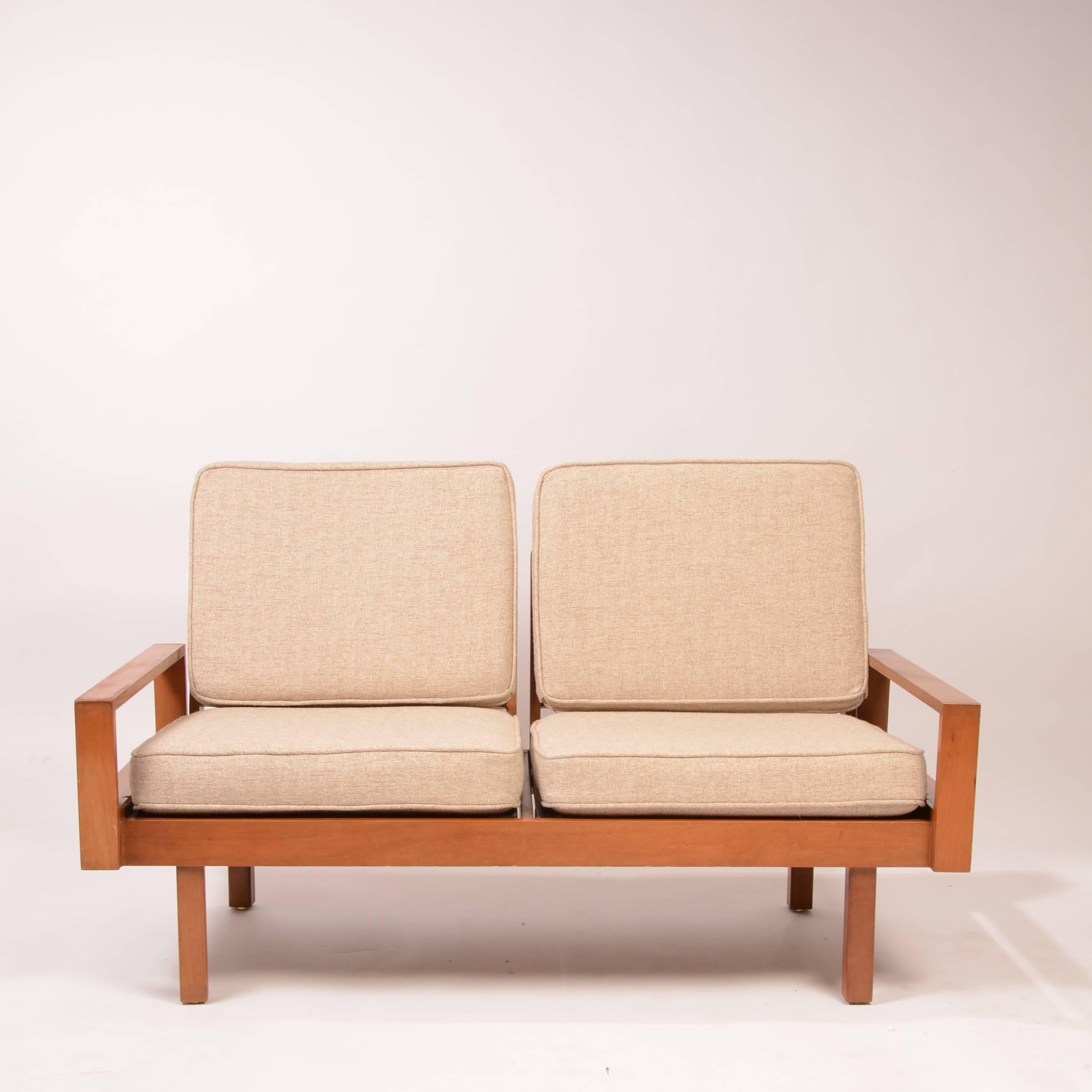 This sofa is part of a modular set by Martin Borenstein for Brown & Saltman. The seats, armrests and walnut tables of this system can be rearranged to any number of ways.  We are selling this set which includes 2 3-bay units, 2 2-bay units, and this