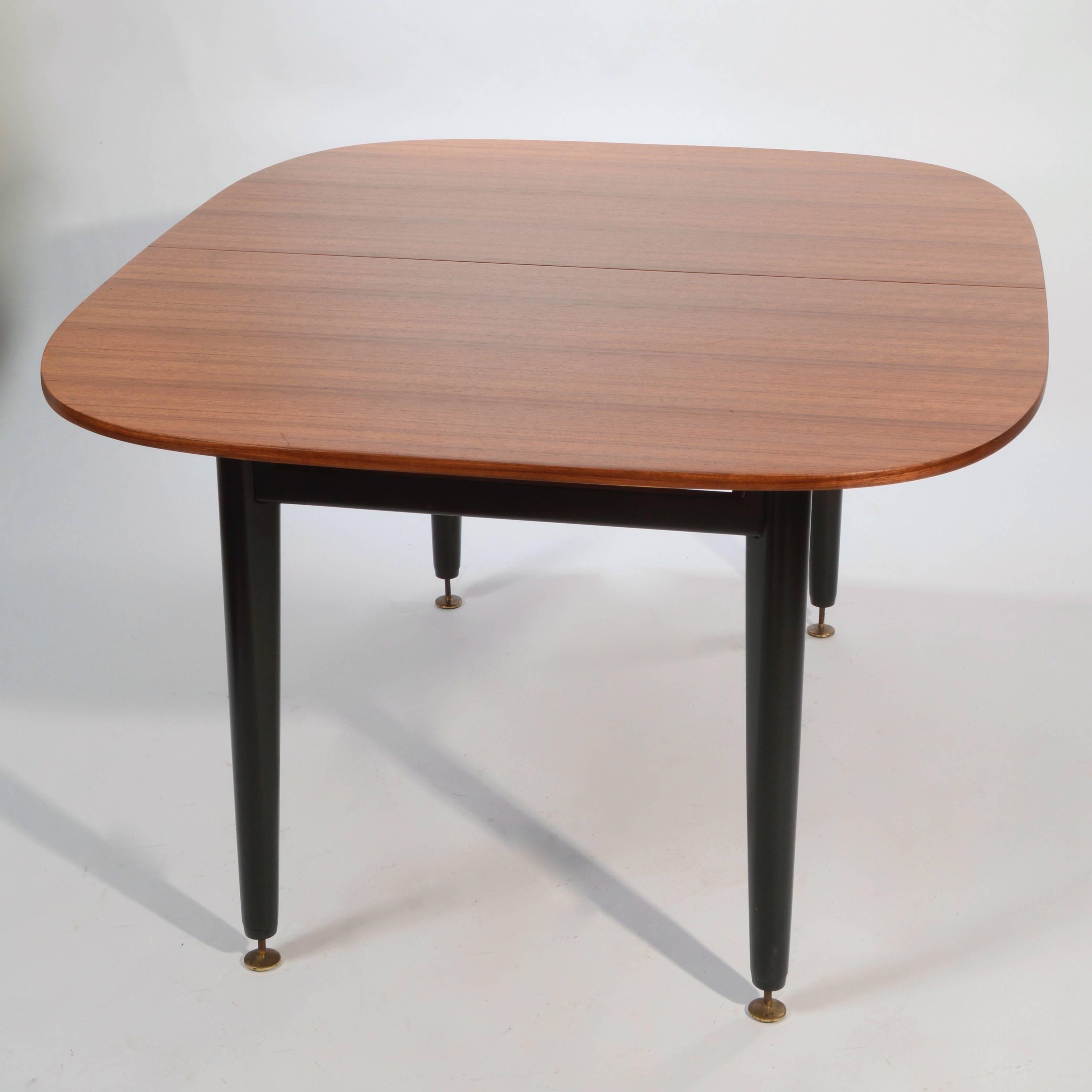 This is a fully restored early dining table by E Gomme, G-Plan for the librenza range in mahogany and black. The 20