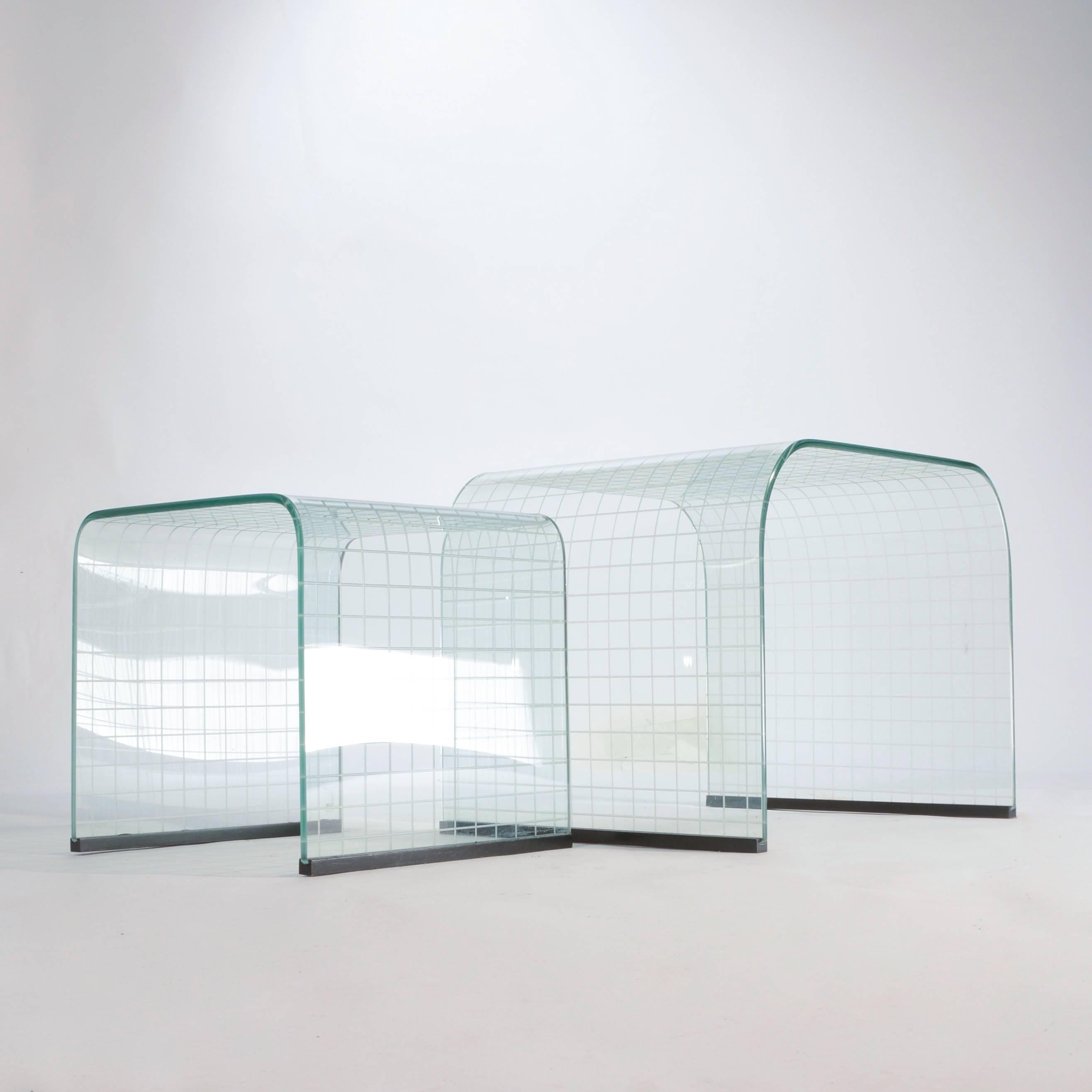 Molded glass nesting tables by Angelo Cortesi, made in Italy. They can nest together or be pulled apart they make a beautiful layered effect. The glass is tempered and the edges are beveled.