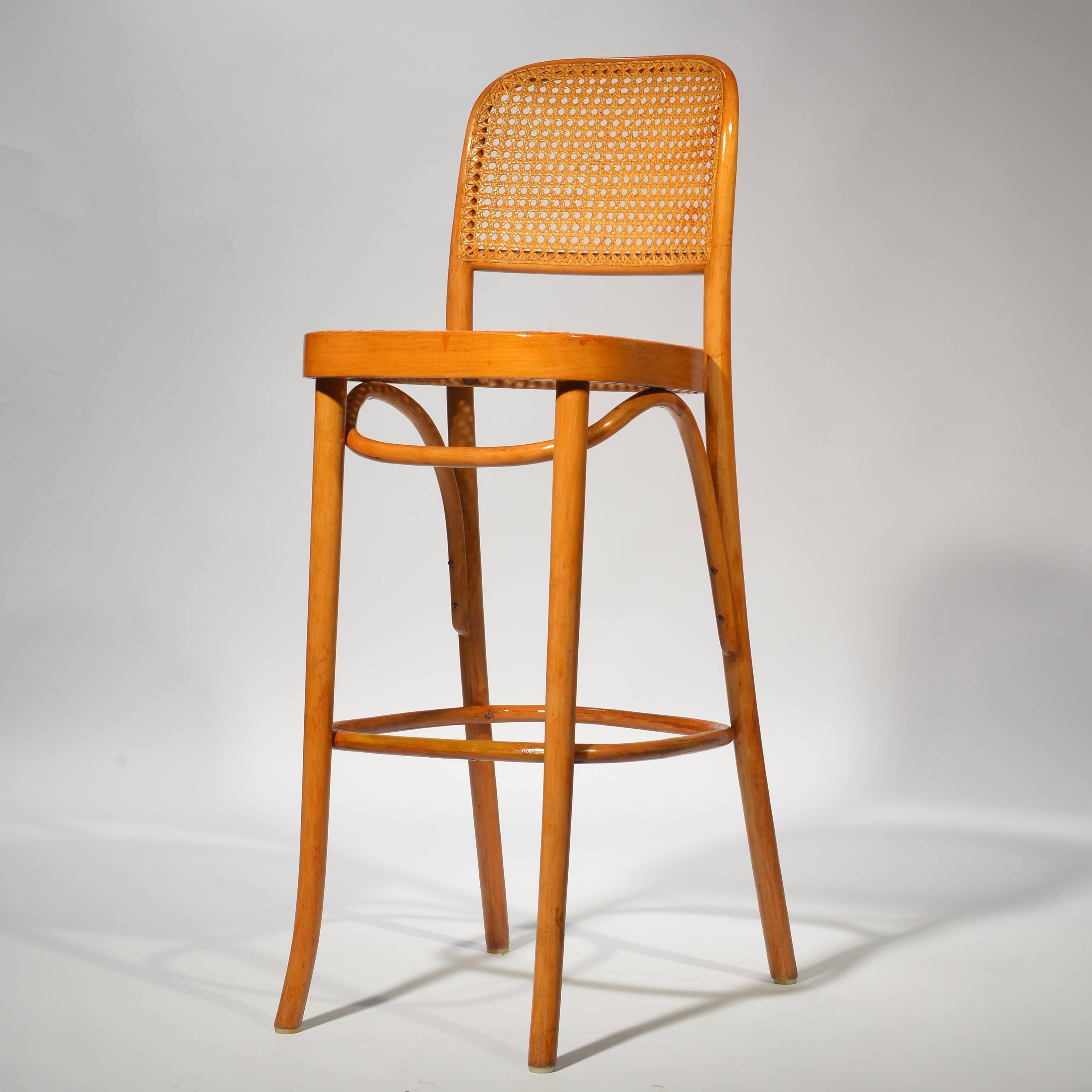 Bar stool designed by Josef Frank and Josef Hoffmann. They feature minimal bentwood sturdy frames in birch with cane seats and backs. Manufactured by MFG for Thonet.

We have one left of this set.  The price is for one stool.  