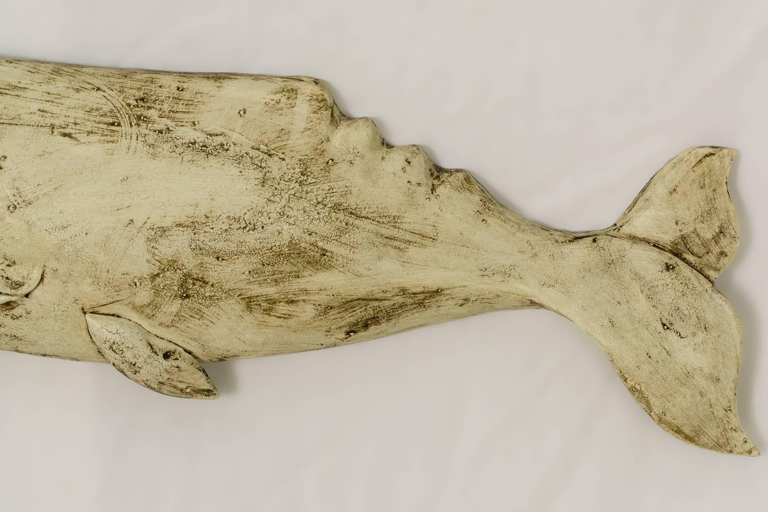 The whale plaque is beautifully carved from basswood and given multiple layers of milk paint to give the finished product a wonderful surface and personality.