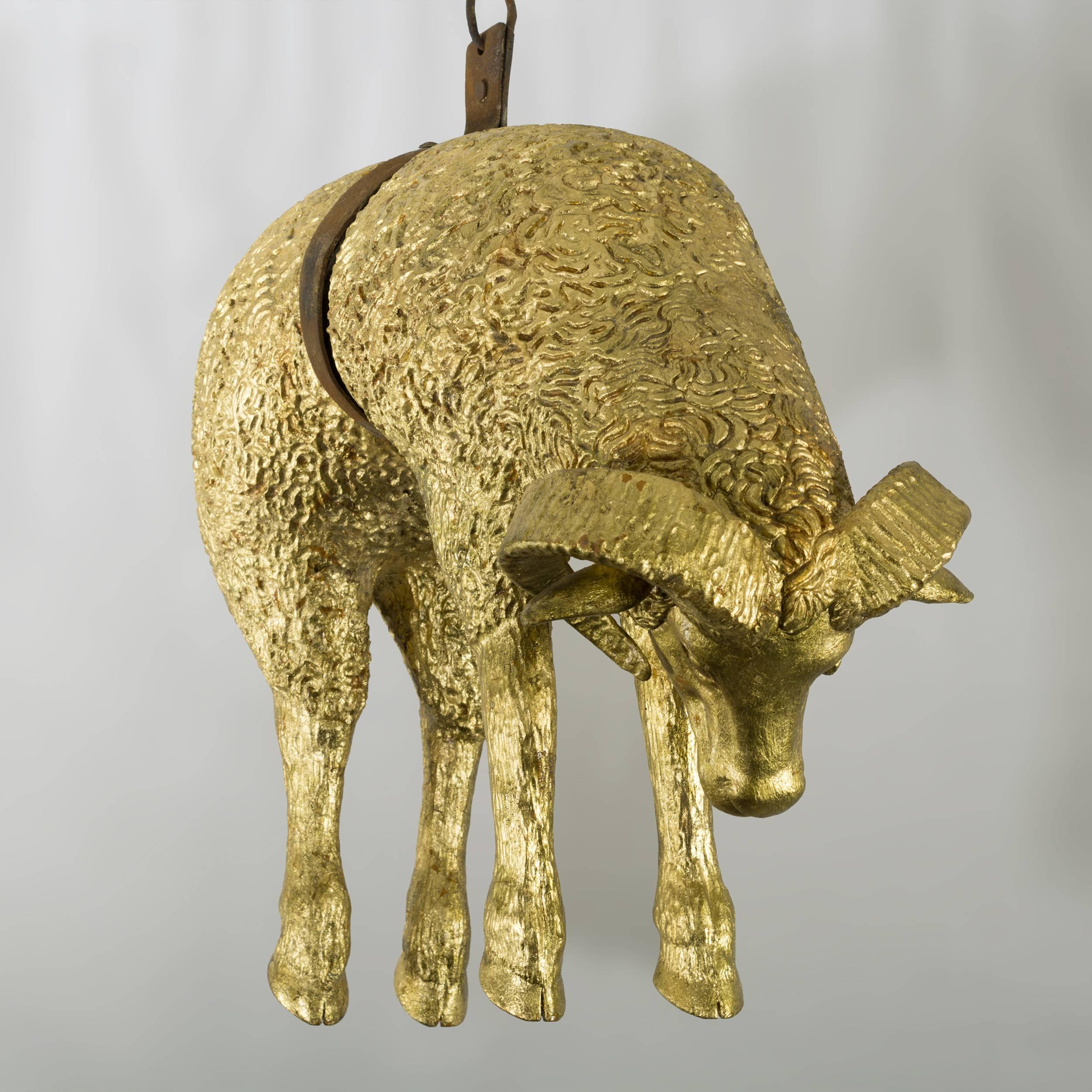 Intricately carved and gilded with an iron hook and chain.
This sculpture is a copy of a traditional trade sign of a London woolen
draper’s shop. The trade sign was an accessible method of 
identifying a tradesman's premises at a time when the