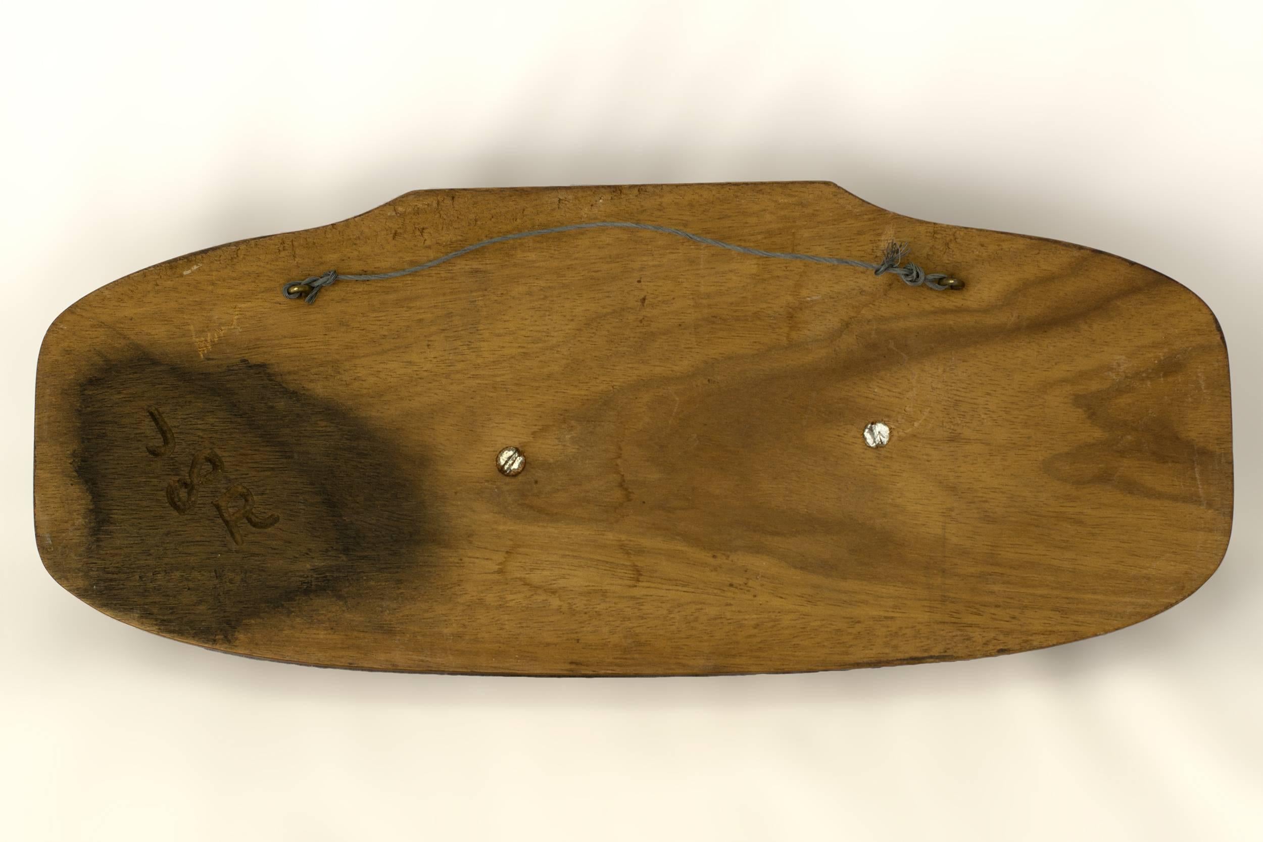 The sperm whale is carved out of black walnut and is mounted on a molded walnut carved plaque.