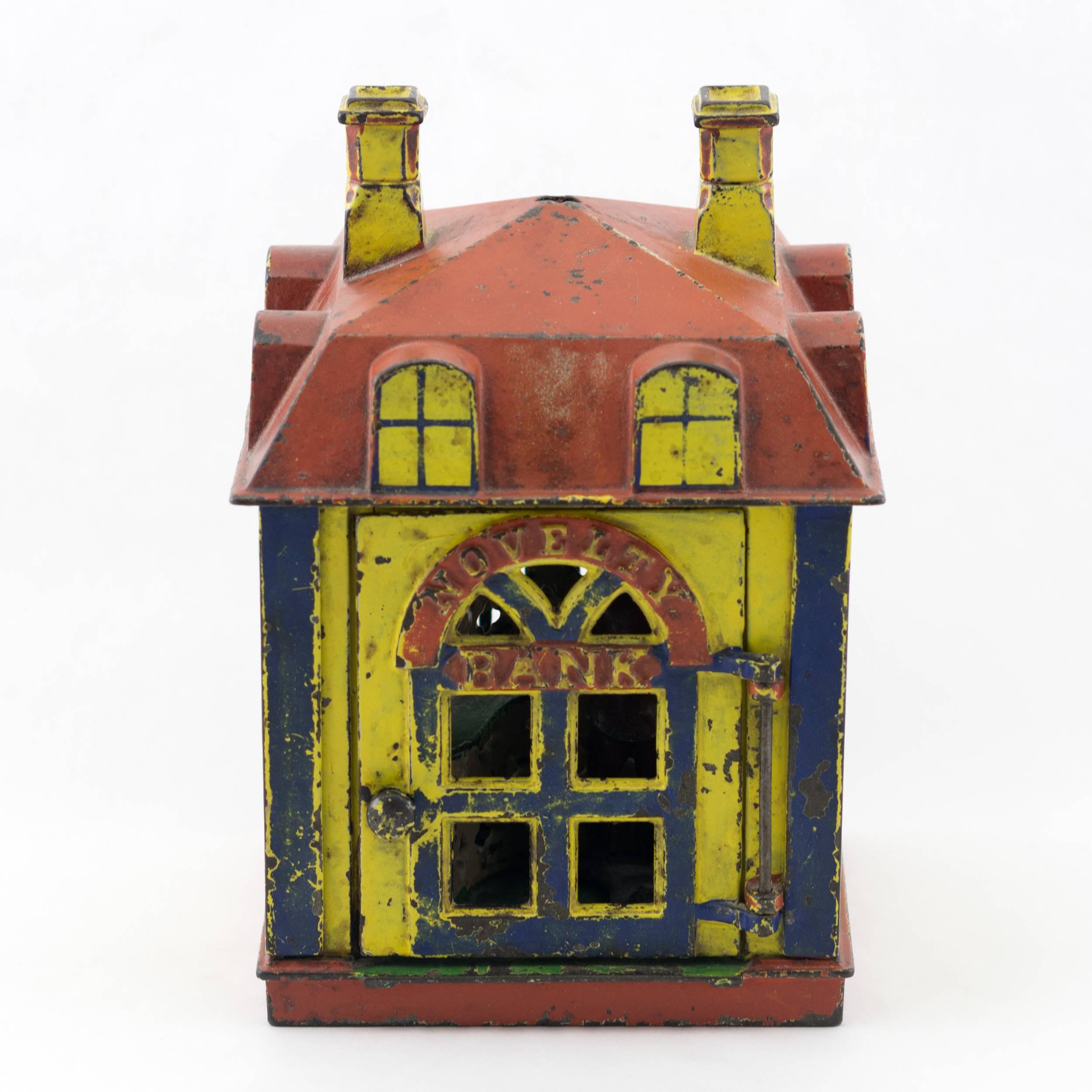 Antique 19th century cast iron mechanical bank by J. & E. Stevens
Super appealing bright original yellow, blue and red paint

circa 1873. The J. & E. Stevens Company of Cromwell, Connecticut manufactured Charles H. Johnson’s Novelty Bank in many