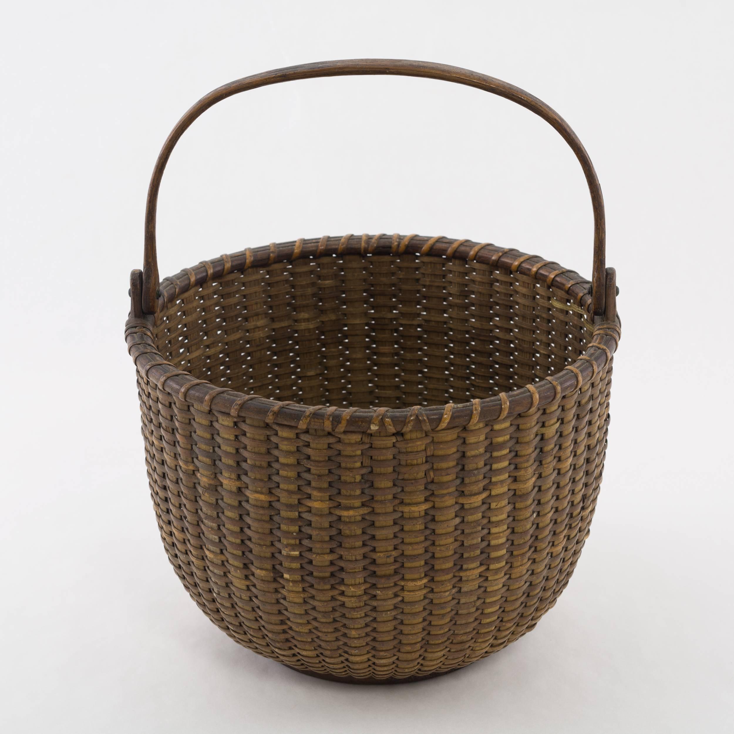 Rare constructed 19th century basket with cane staves and oak ears that are finely shaped and extend to the bottom plaque, the bottom plaque is heavily turned and is scribed on the interior of the base. Most likely used as a berry basket.