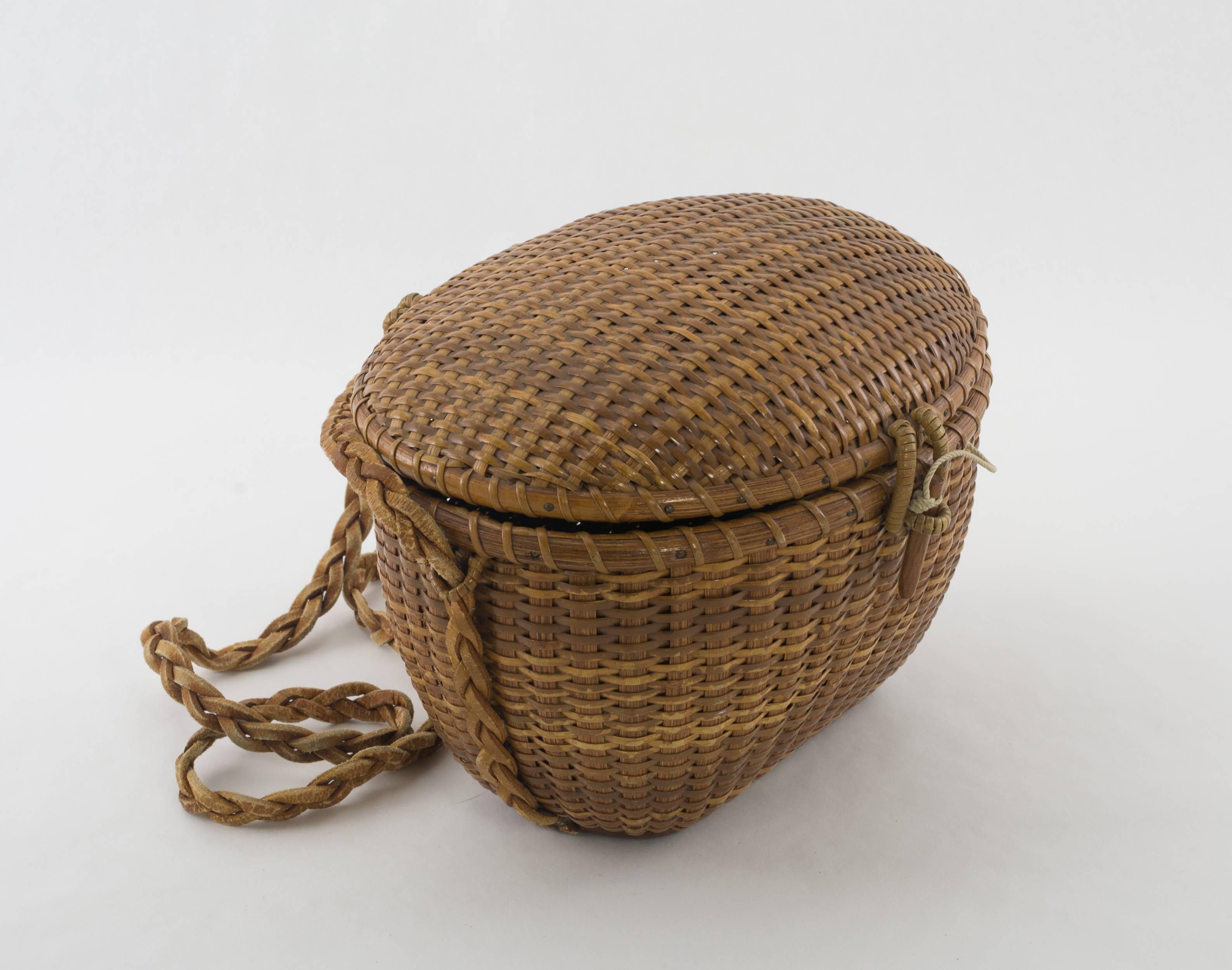 Very rare Nantucket lightship friendship basket shoulder purse by Jose Formosa Reyes. This early form was the prototype of today's Nantucket purse.
The unusual top is woven with reed and cane the bottom section is woven with oak staves and reed.