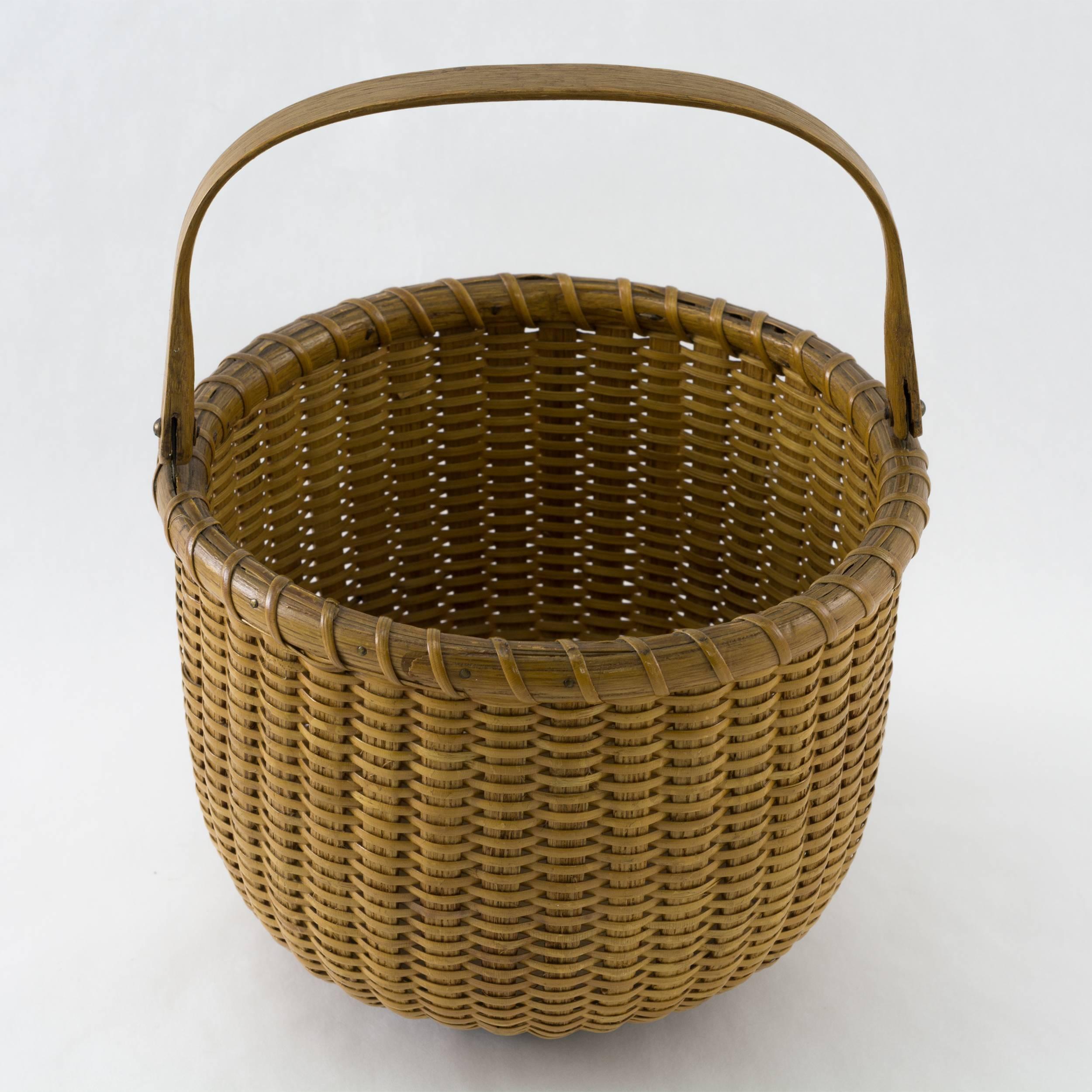 Open round basket with oak staves, handle and walnut bottom.
Pristine condition with original paper label reading
