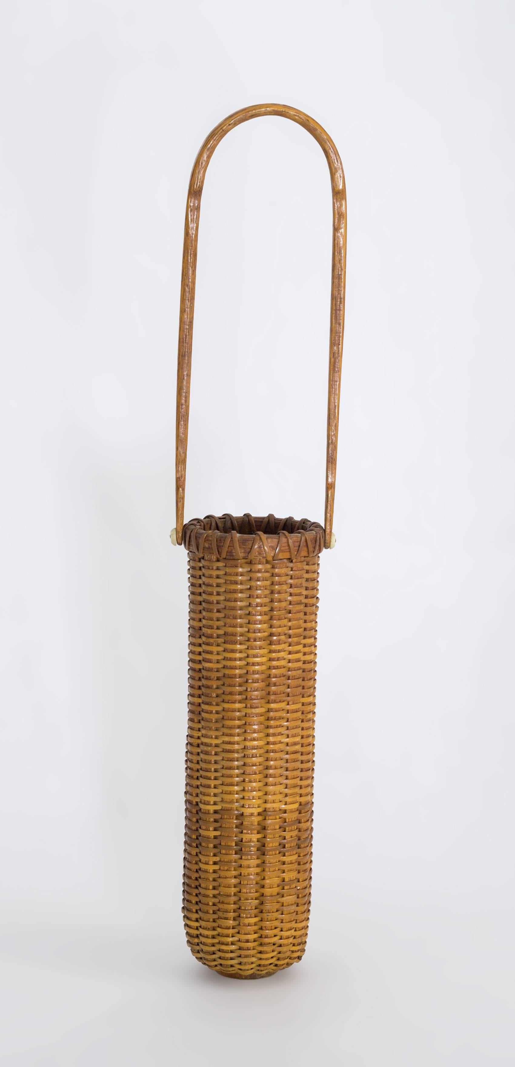 The basket has a glass liner with a elongated swing handle and has a nice rich honey patina. Paul Willer made Nantucket lightship baskets at the House of Orange from the 1970s thru the 1990s. His baskets have become highly collectible.